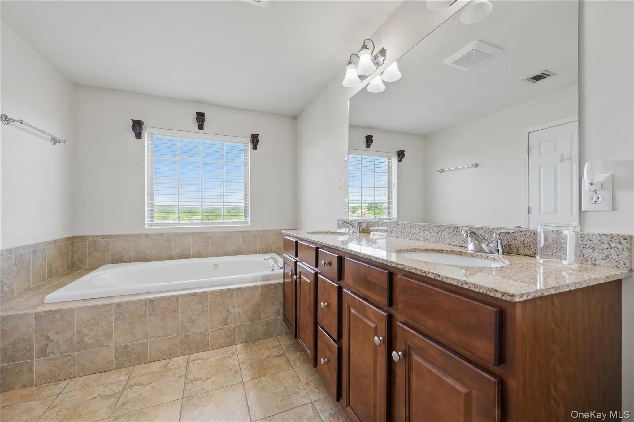 Bathroom featuring a garden tub and double vanity Bathroom featuring a garden tub and double vanity