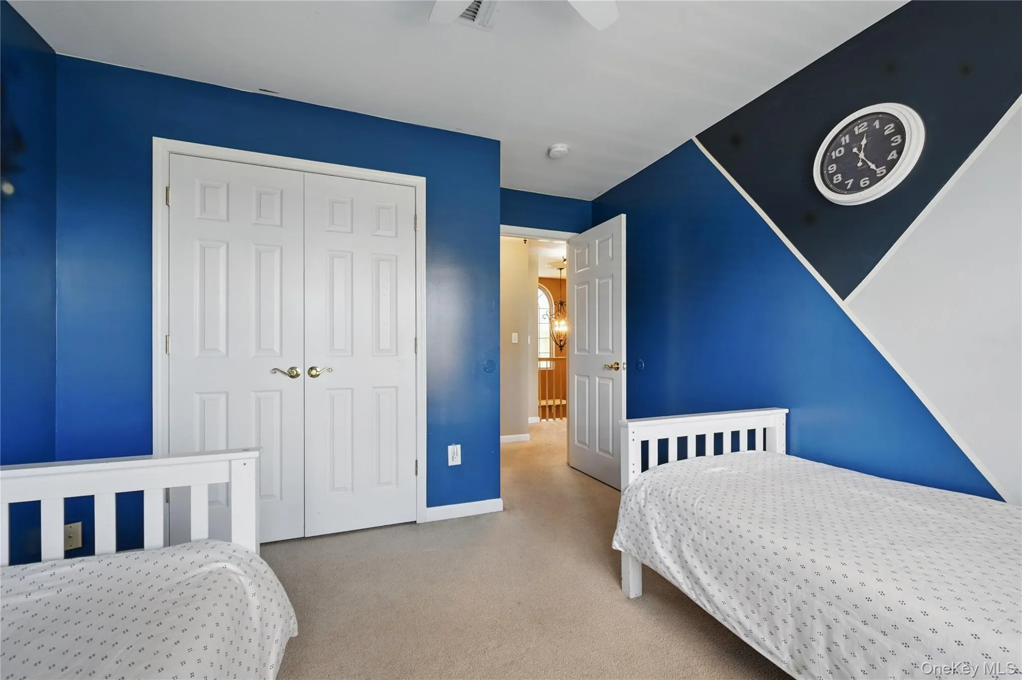 Carpeted bedroom with a closet and baseboards Carpeted bedroom with a closet and baseboards