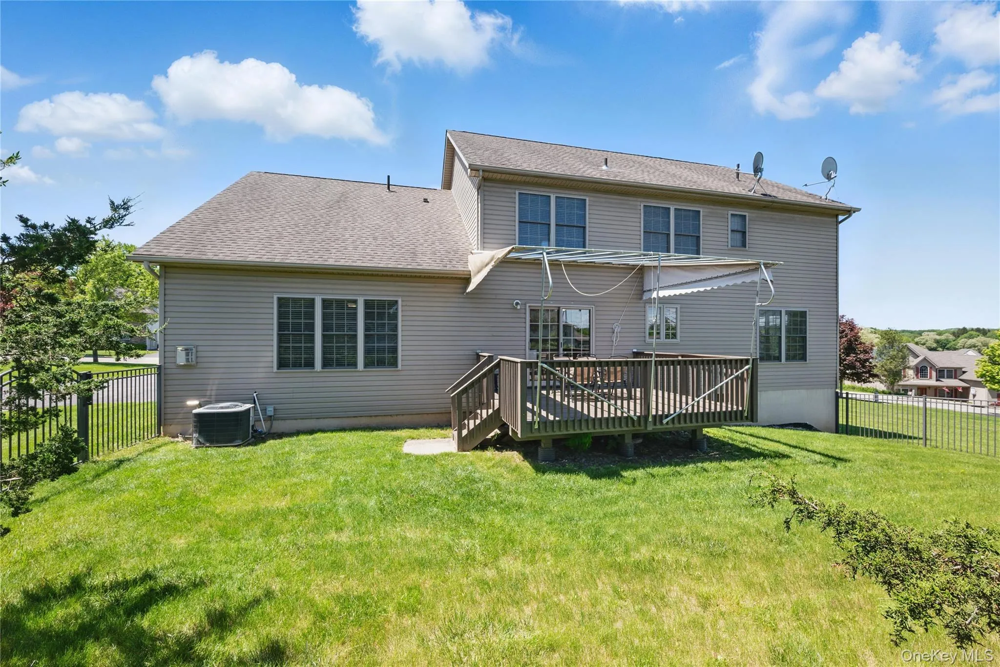 Back of house featuring a wooden deck and central air condition unit Back of house featuring a wooden deck and central air condition unit