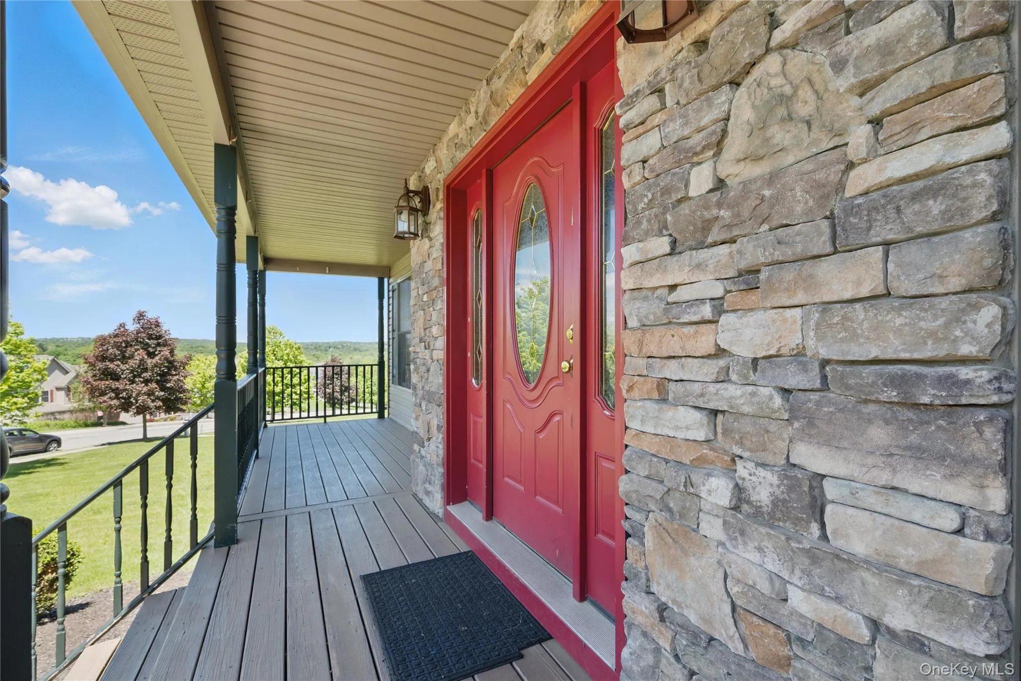 Property entrance with stone siding and covered porch Property entrance with stone siding and covered porch