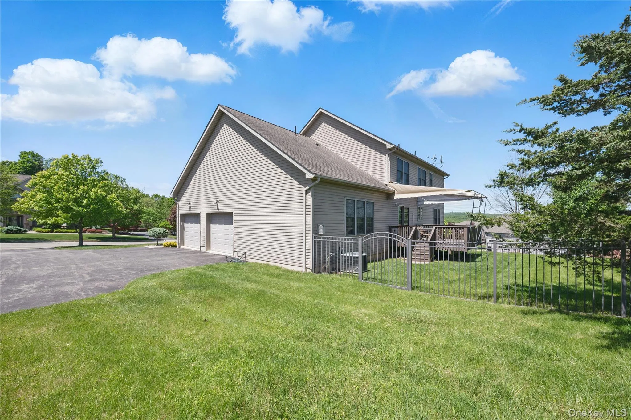 View of side of home featuring driveway and a garage View of side of home featuring driveway and a garage