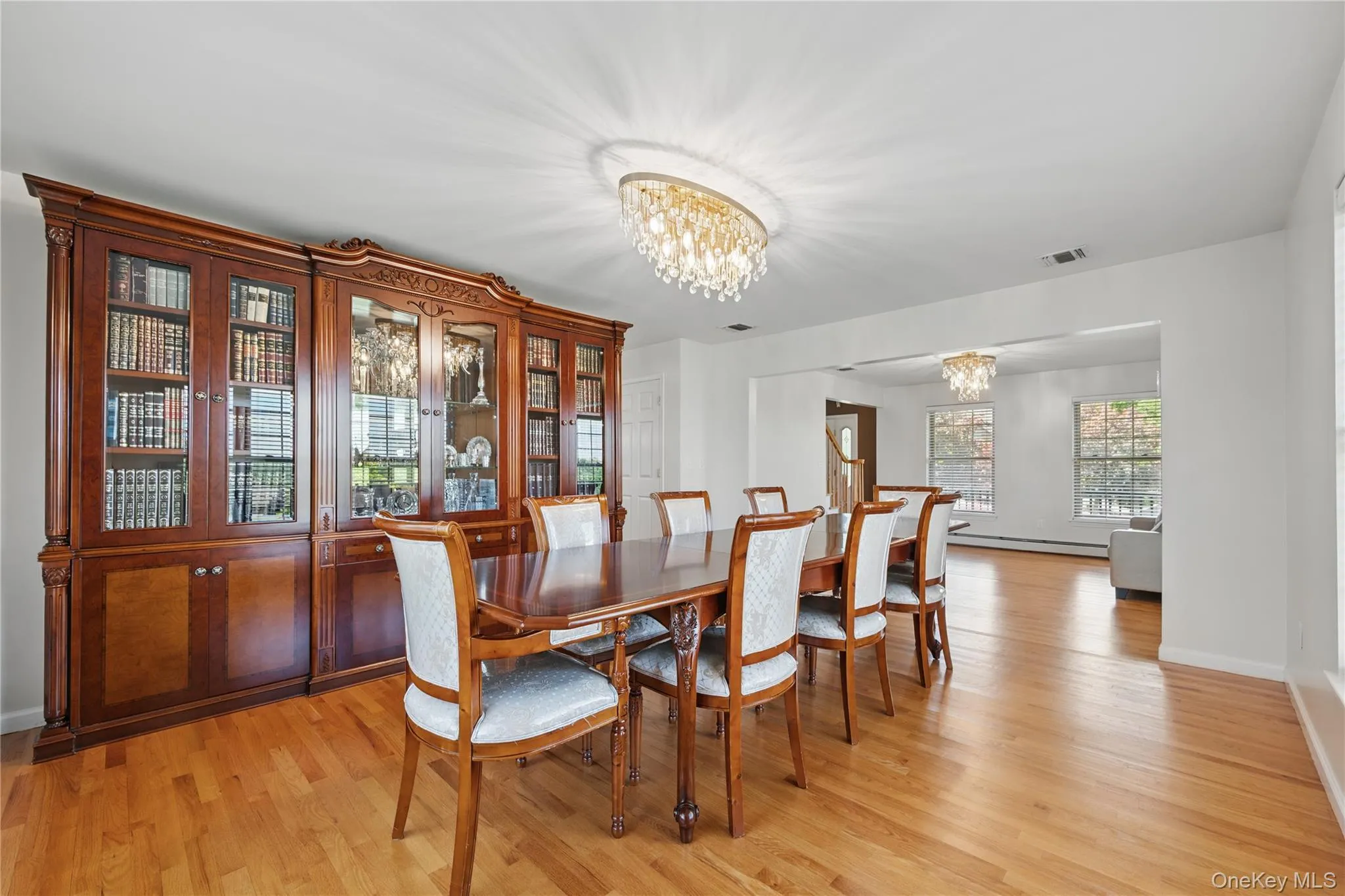 Dining space with a chandelier, light wood-type flooring, and baseboards Dining space with a chandelier, light wood-type flooring, and baseboards