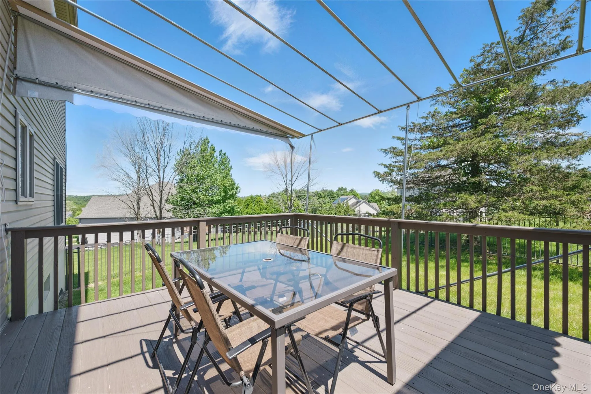 Deck featuring outdoor dining space and a lawn Deck featuring outdoor dining space and a lawn