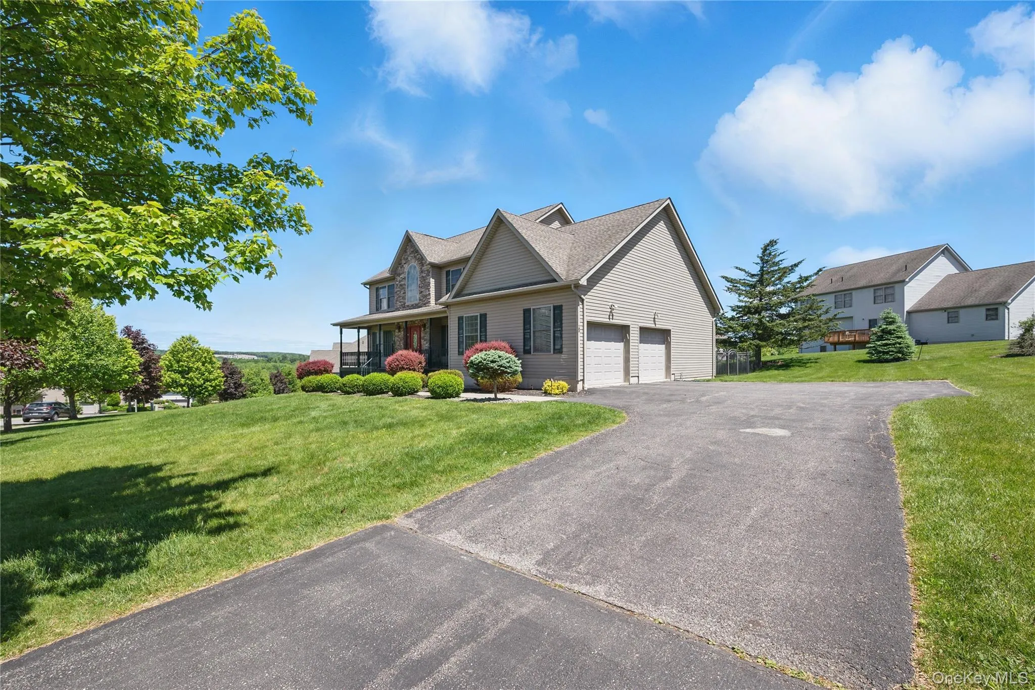 View of front facade with driveway and a front yard View of front facade with driveway and a front yard