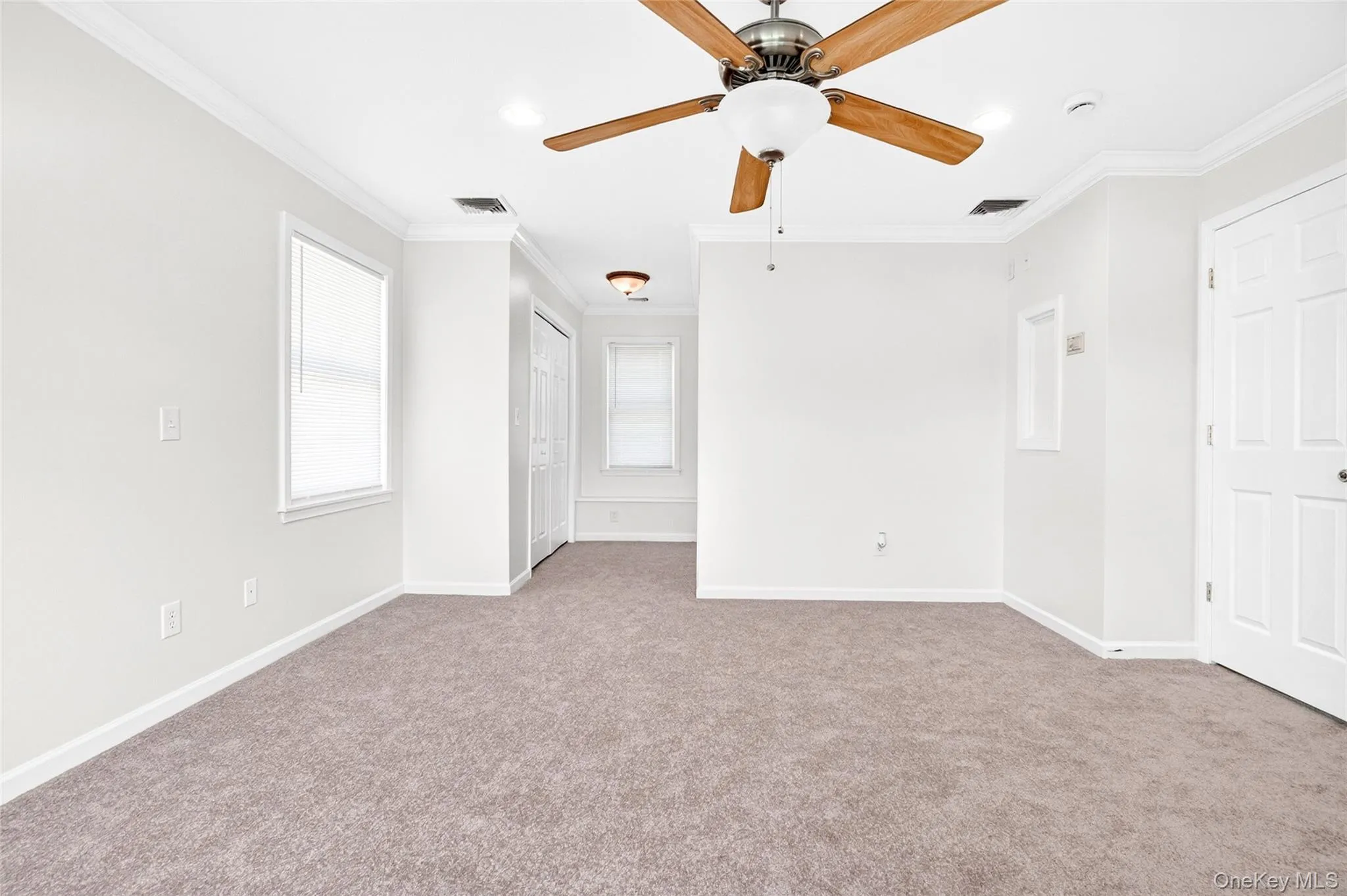 Spacious primary bedroom featuring crown molding, ceiling fan, and generous layout Spacious primary bedroom featuring crown molding, ceiling fan, and generous layout