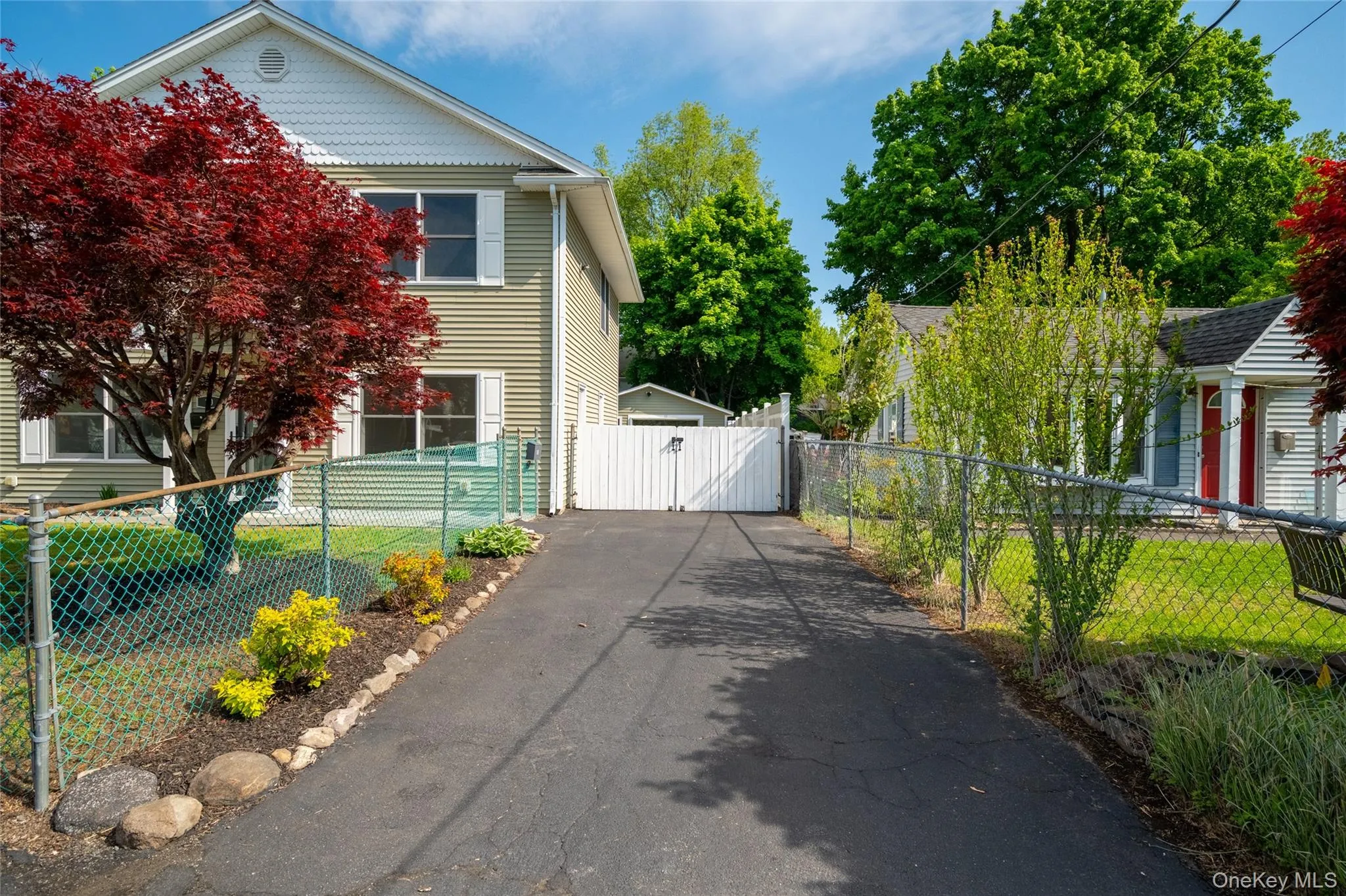 Extended driveway leading to detached garage and backyard access Extended driveway leading to detached garage and backyard access