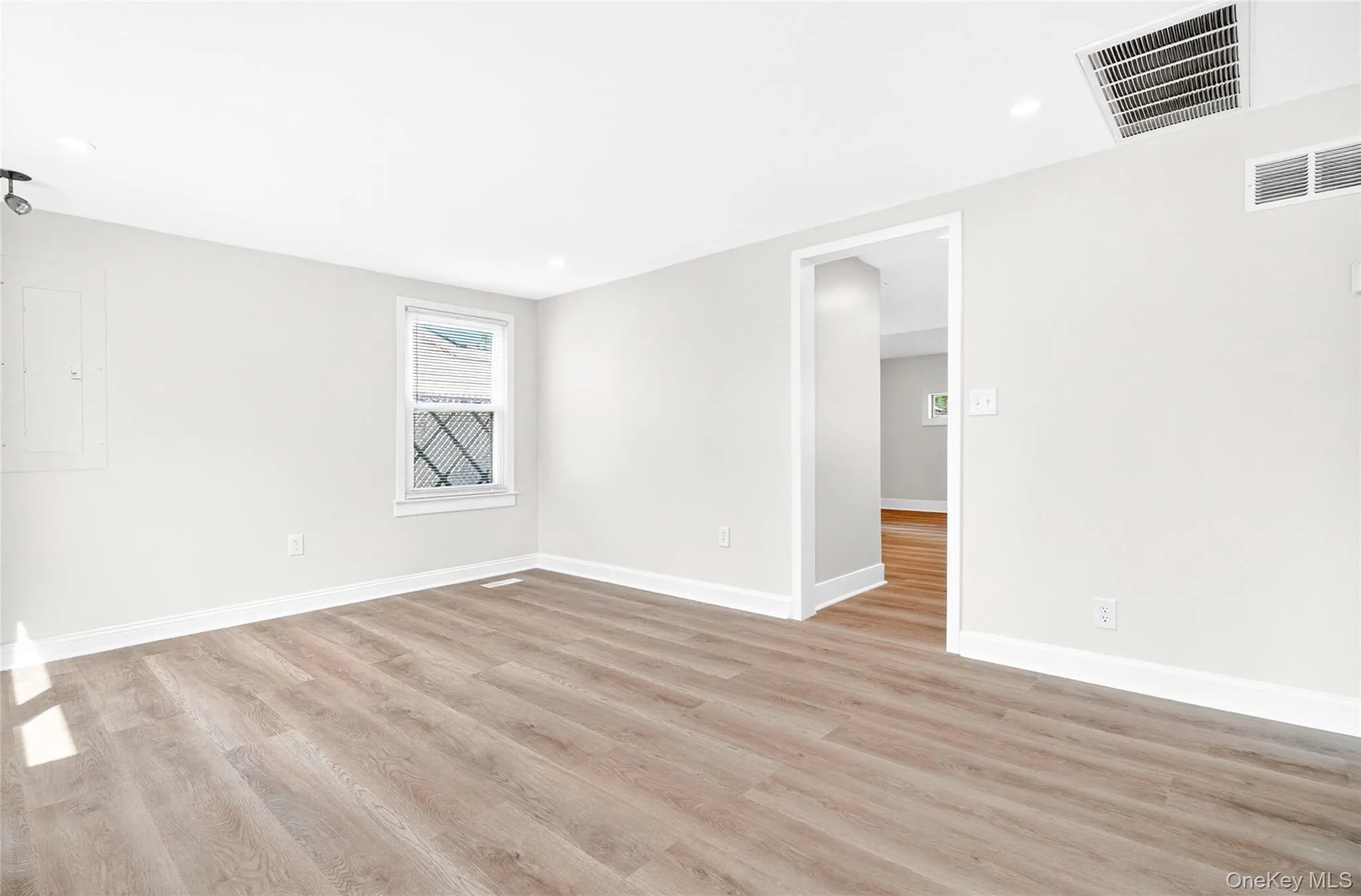 Bright and open living area with updated flooring Bright and open living area with updated flooring