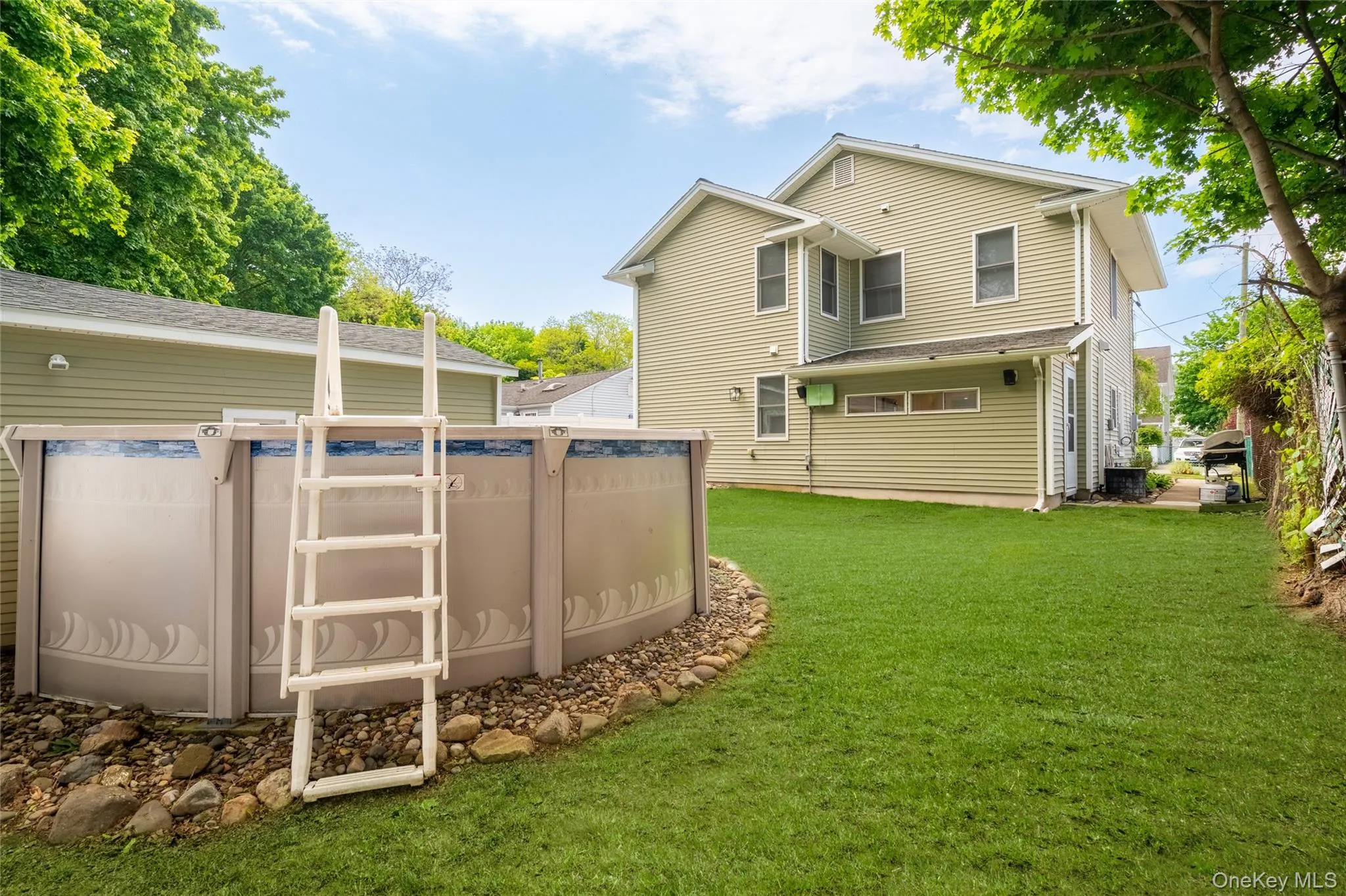 Backyard featuring above ground pool and detached garage Backyard featuring above ground pool and detached garage