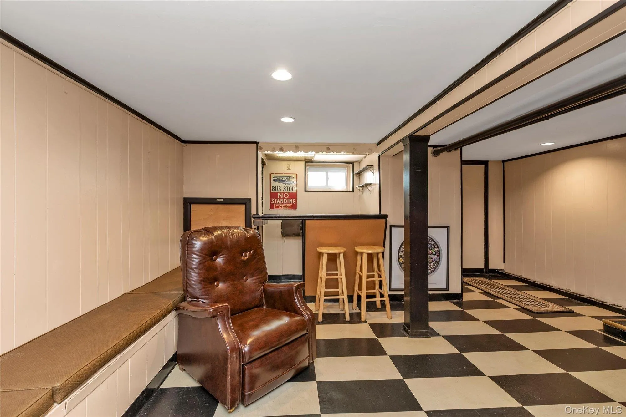 Finished basement featuring a built-in bar, checkered flooring, recessed lighting, and a long built-in bench Finished basement featuring a built-in bar, checkered flooring, recessed lighting, and a long built-in bench