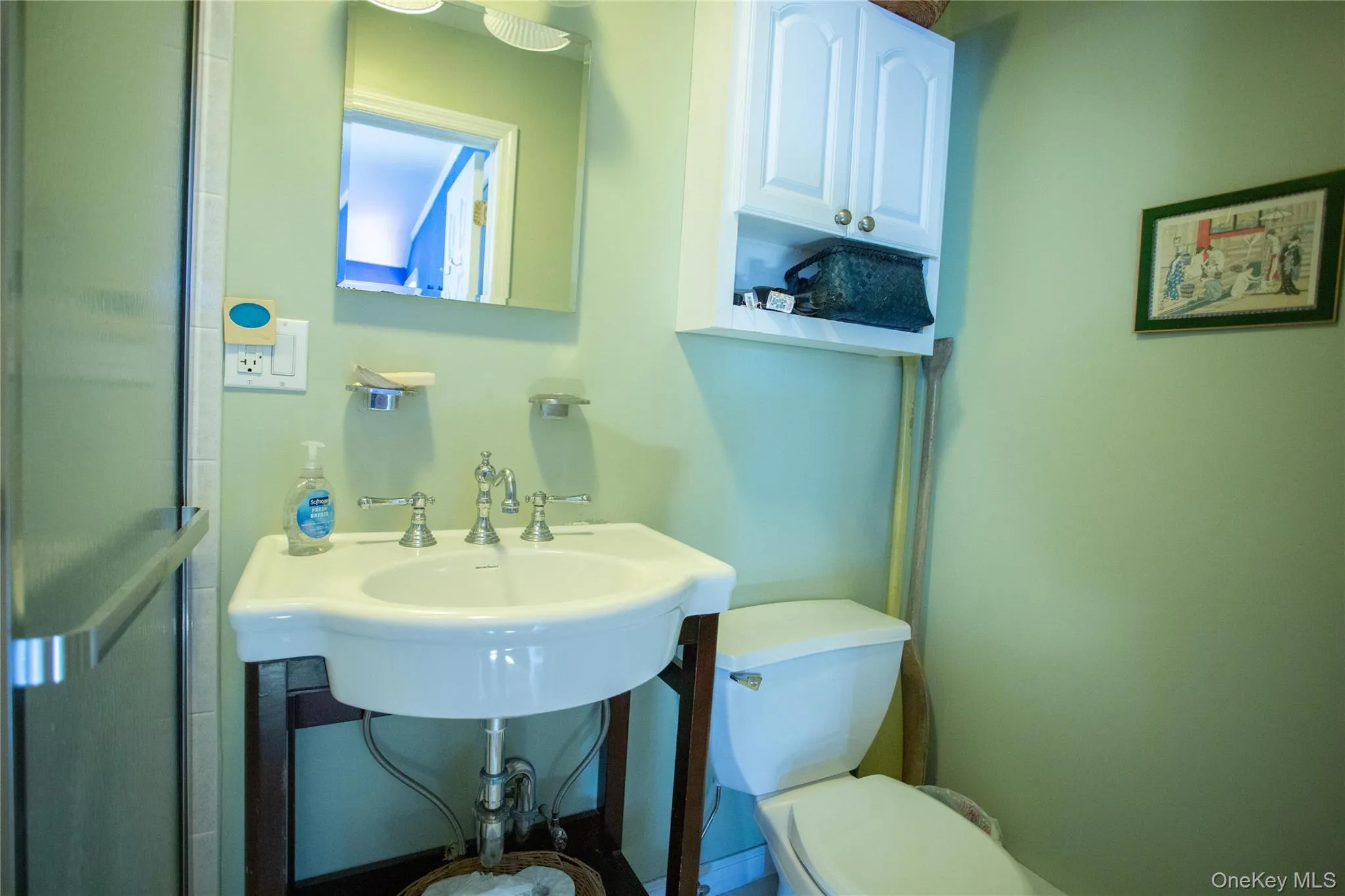 Bathroom featuring toilet and a sink Bathroom featuring toilet and a sink