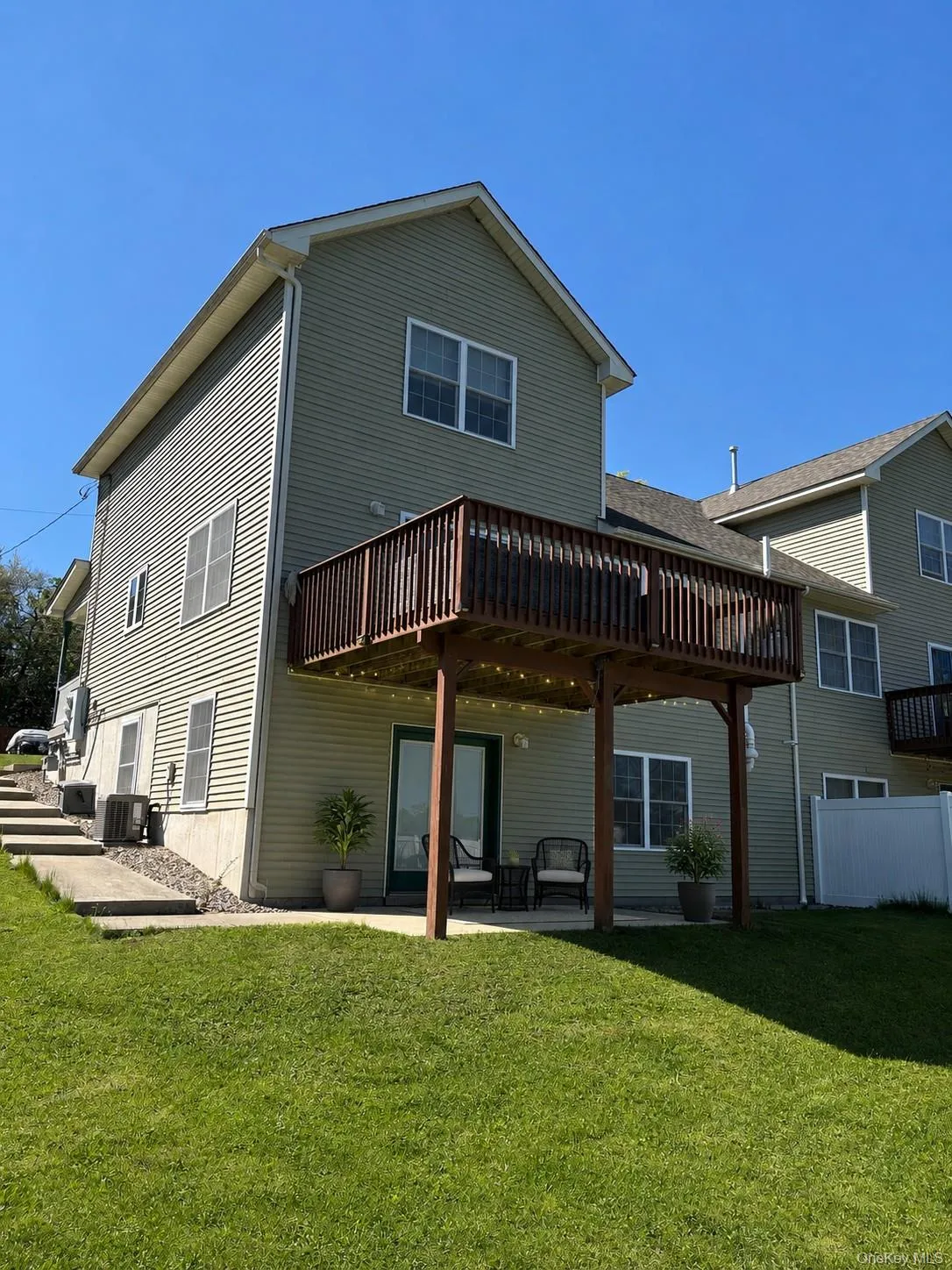 View of the back of the duplex and yard. Features privacy fence dividing the yard to give occupants their own space. View of the back of the duplex and yard. Features privacy fence dividing the yard to give occupants their own space.