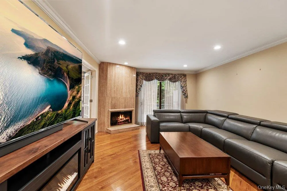 Living area featuring hardwood flooring, recessed lighting, and crown molding Living area featuring hardwood flooring, recessed lighting, and crown molding