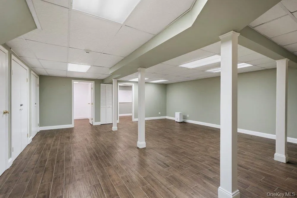 Finished basement with wood-finish flooring, recessed lighting, and drop ceiling Finished basement with wood-finish flooring, recessed lighting, and drop ceiling