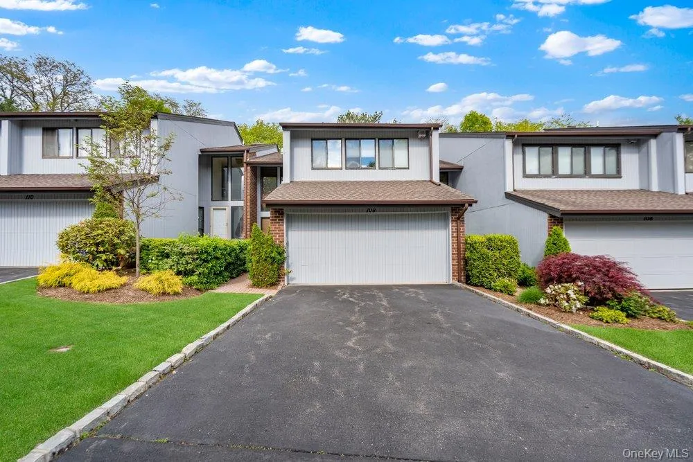 Contemporary facade with a single-car garage and asphalt driveway Contemporary facade with a single-car garage and asphalt driveway