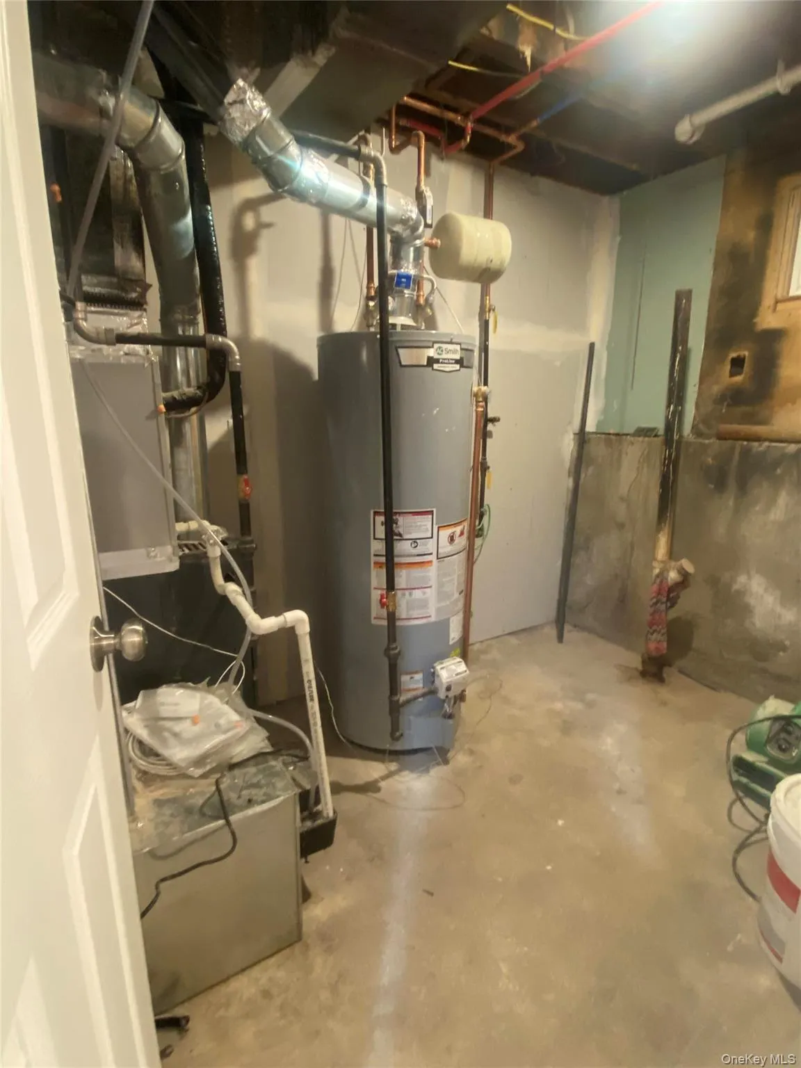 Utility room featuring a water heater and furnace Utility room featuring a water heater and furnace