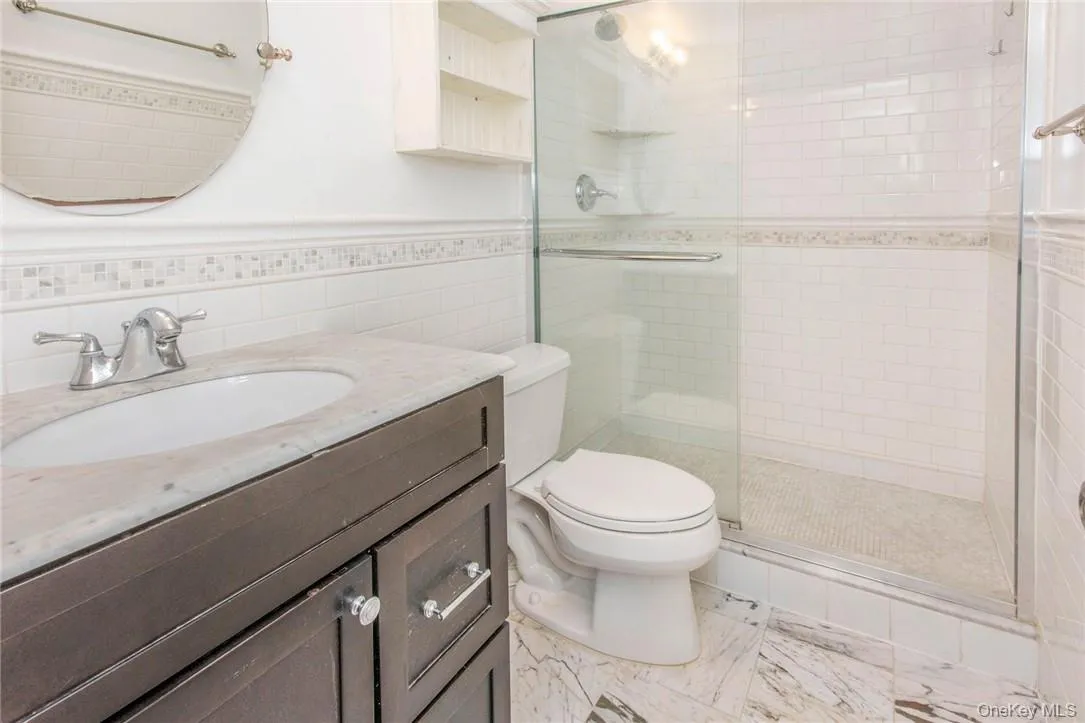 En suite marble primary bath with shower En suite marble primary bath with shower
