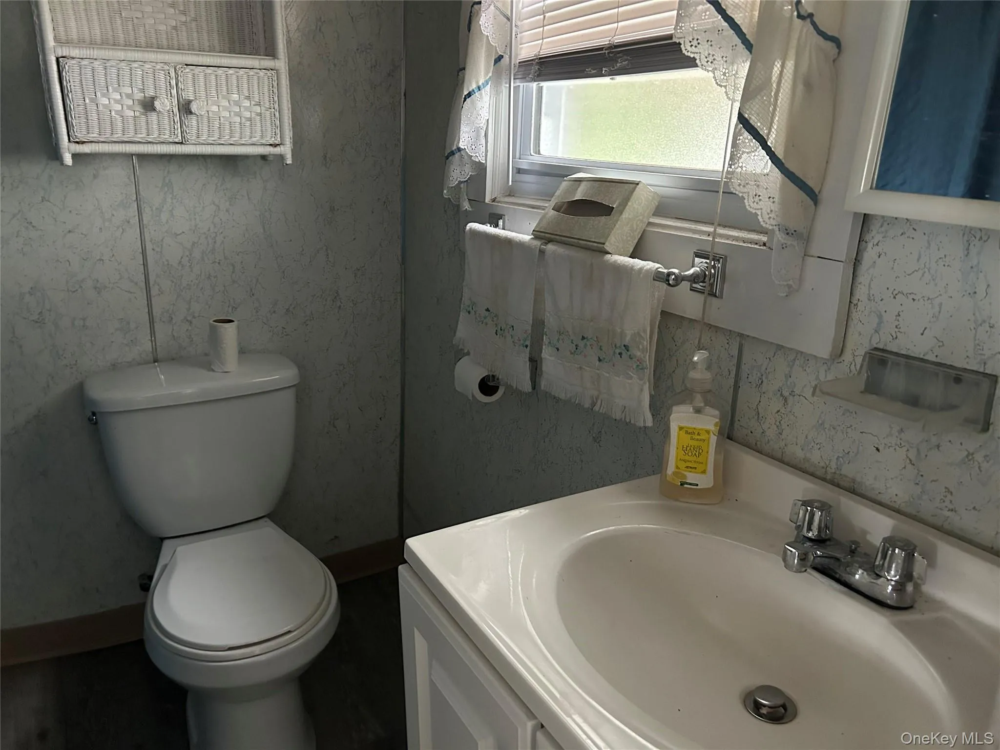 Half bathroom with toilet and vanity Half bathroom with toilet and vanity