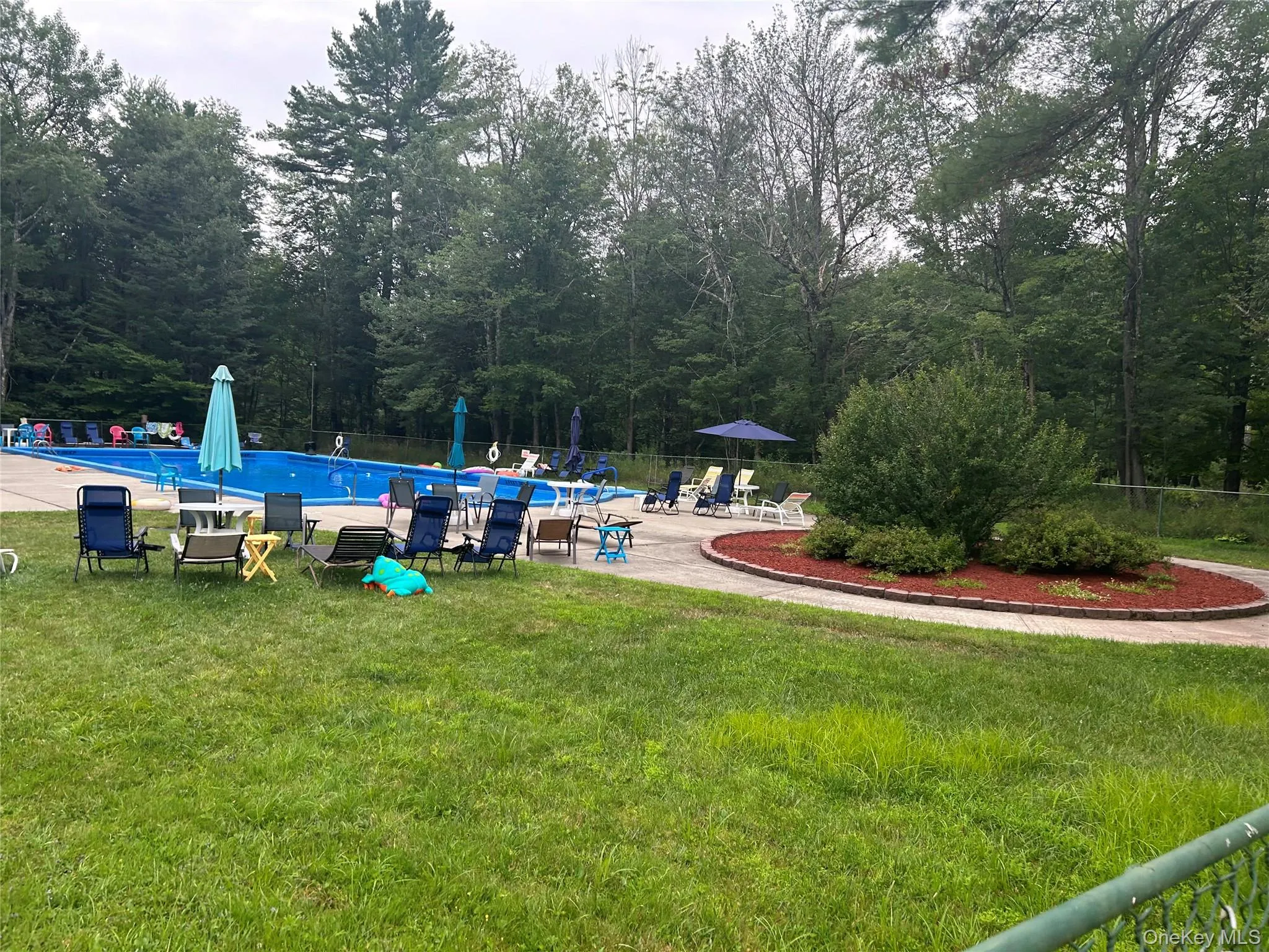 View of yard featuring a community pool and a patio View of yard featuring a community pool and a patio