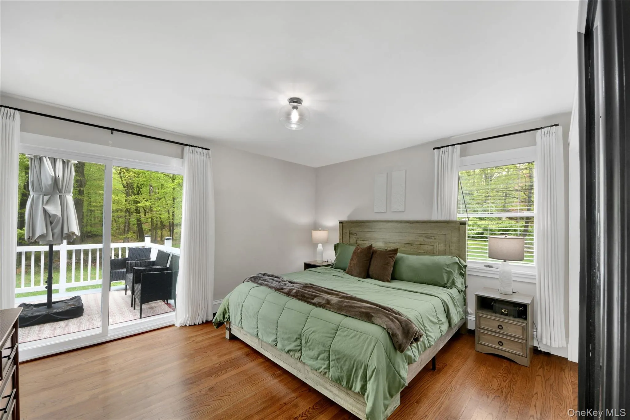 Primary bedroom w/glass sliders to deck Primary bedroom w/glass sliders to deck