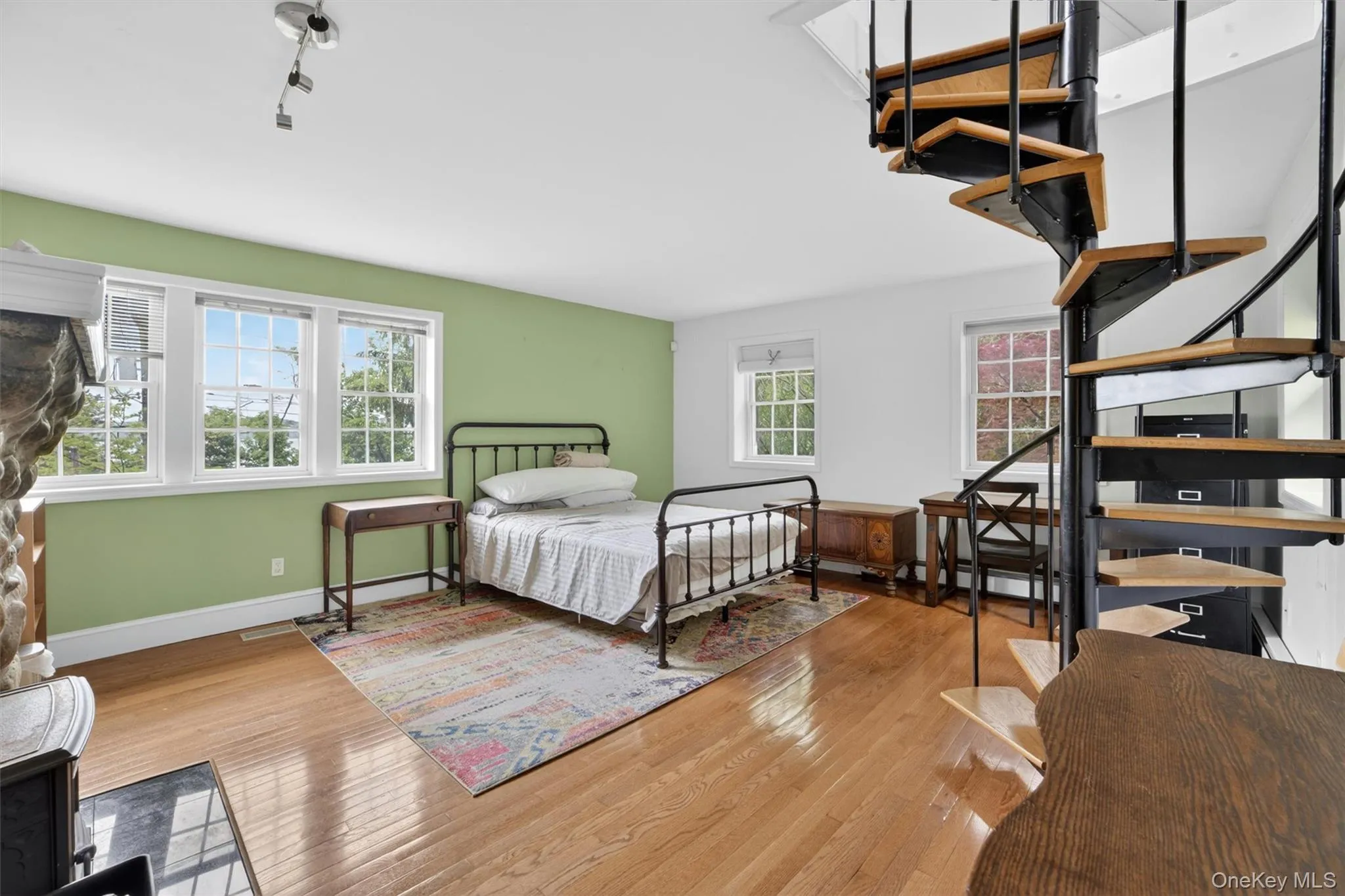 Light-filled primary bedroom offering Hudson River views, a gorgeous stone fireplace, and seamless access to the home’s private living spaces. Light-filled primary bedroom offering Hudson River views, a gorgeous stone fireplace, and seamless access to the home’s private living spaces.