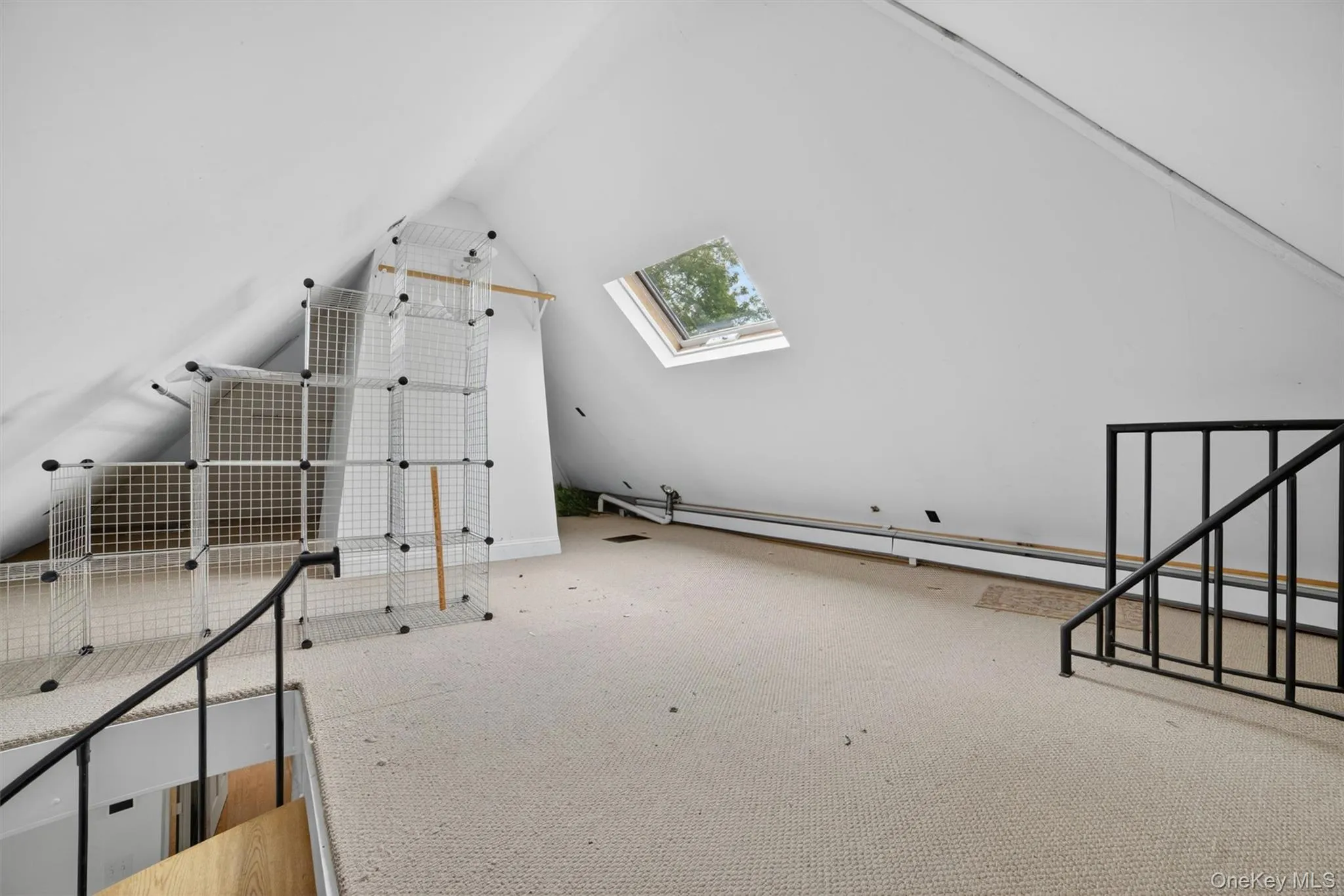 Spiral staircase leads to a versatile bonus room ideal for a home office, walk-in closet, studio, or additional flexible living space. Spiral staircase leads to a versatile bonus room ideal for a home office, walk-in closet, studio, or additional flexible living space.