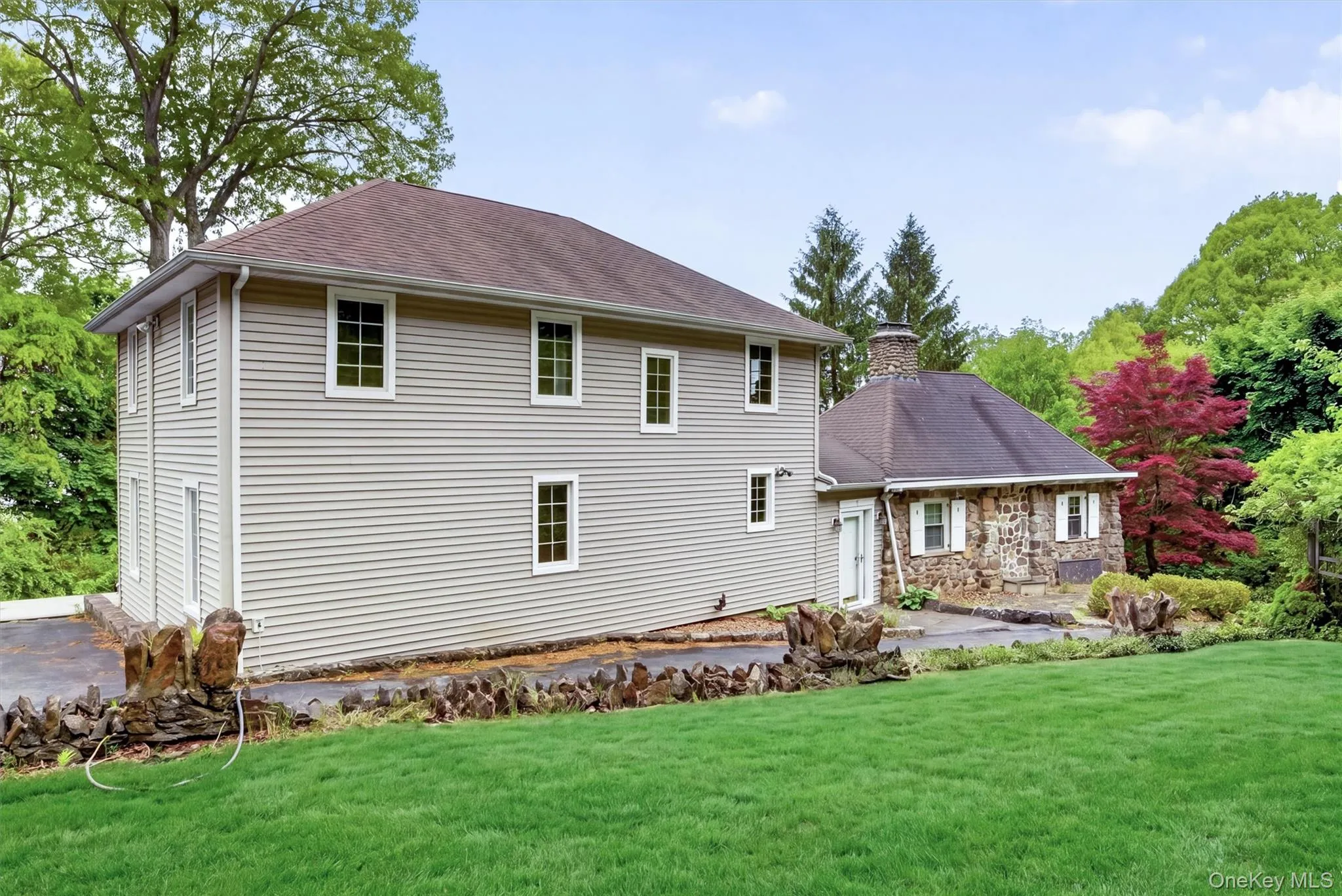 Exterior front of home featuring original stone pillars and historic stone walls. Exterior front of home featuring original stone pillars and historic stone walls.