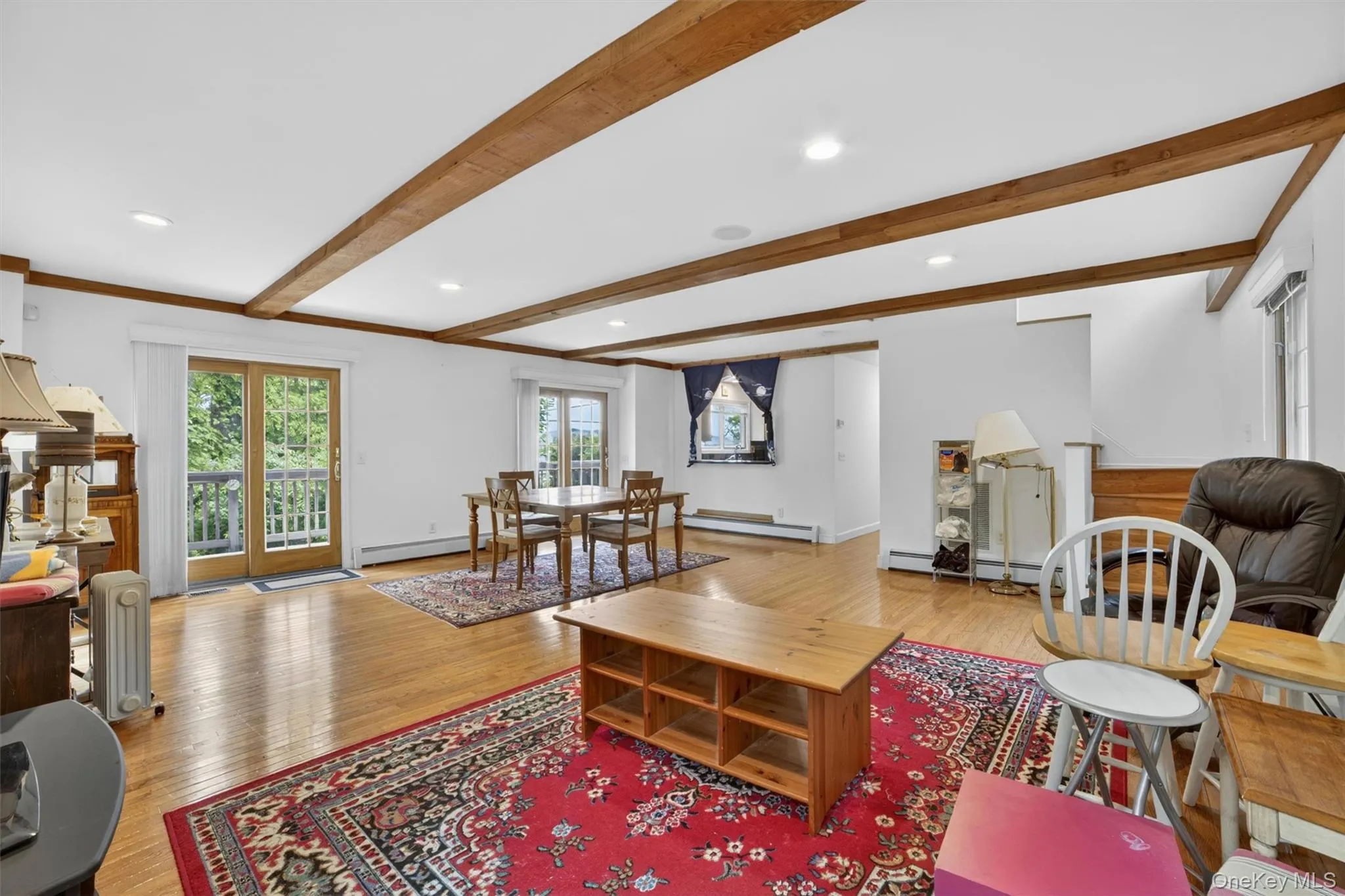 Bright and airy open-concept living space filled with natural light. Double sliding doors leading to deck. Bright and airy open-concept living space filled with natural light. Double sliding doors leading to deck.