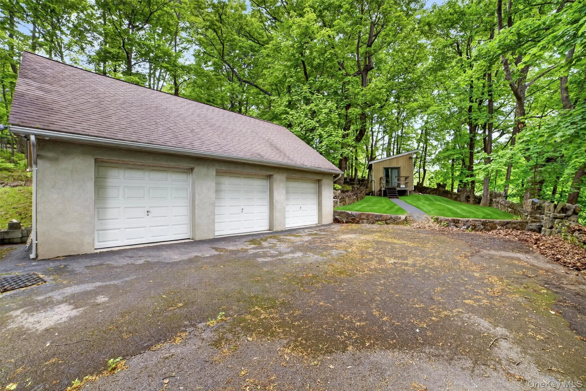 Detached three-car garage with an expansive loft above garage with electric — ideal for studio, gym, or workshop. Detached three-car garage with an expansive loft above garage with electric — ideal for studio, gym, or workshop.