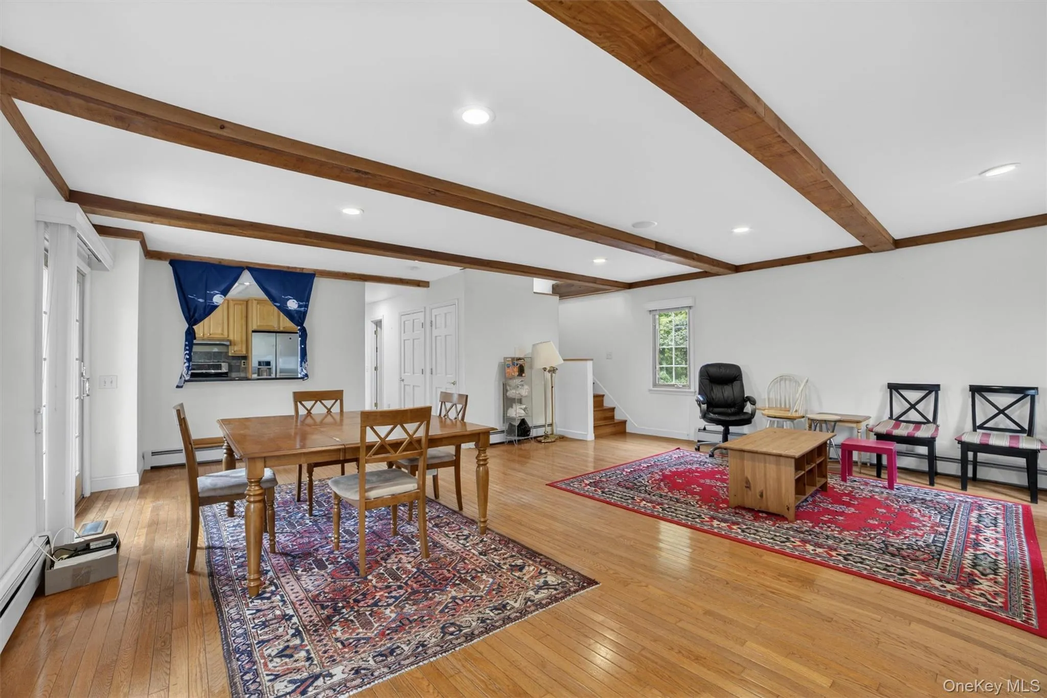 Dining area with an open view into the living room, creating a seamless and connected main living space perfect for gathering and hosting. Dining area with an open view into the living room, creating a seamless and connected main living space perfect for gathering and hosting.
