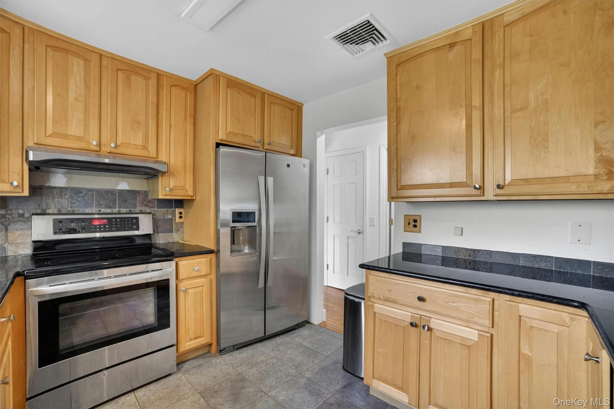 Beautifully updated kitchen with granite countertops and stainless-steel appliances. Beautifully updated kitchen with granite countertops and stainless-steel appliances.