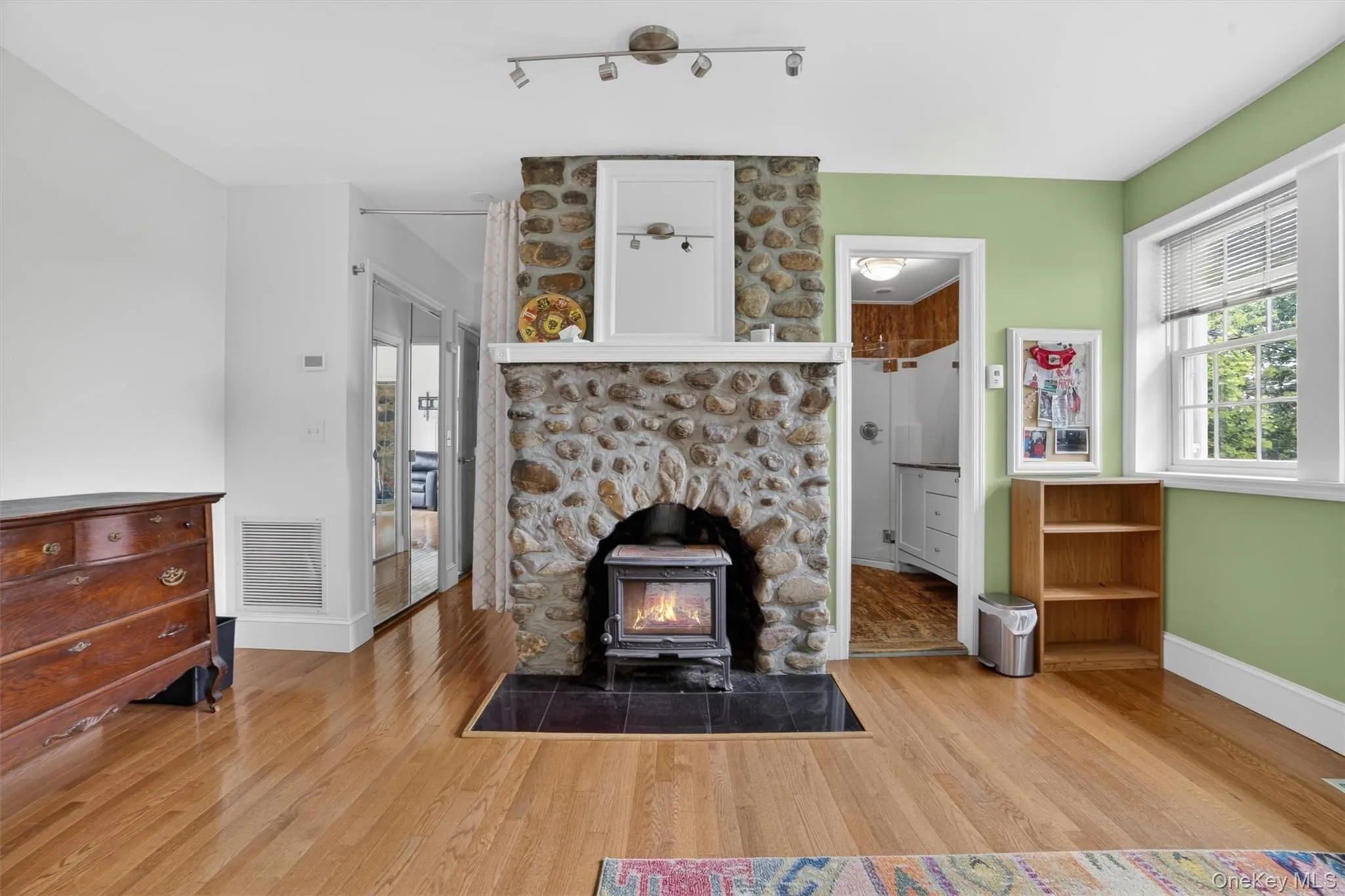 Primary bedroom stone fireplace serving as a striking focal point, adding warmth, character, and timeless charm to the space. Primary bedroom stone fireplace serving as a striking focal point, adding warmth, character, and timeless charm to the space.