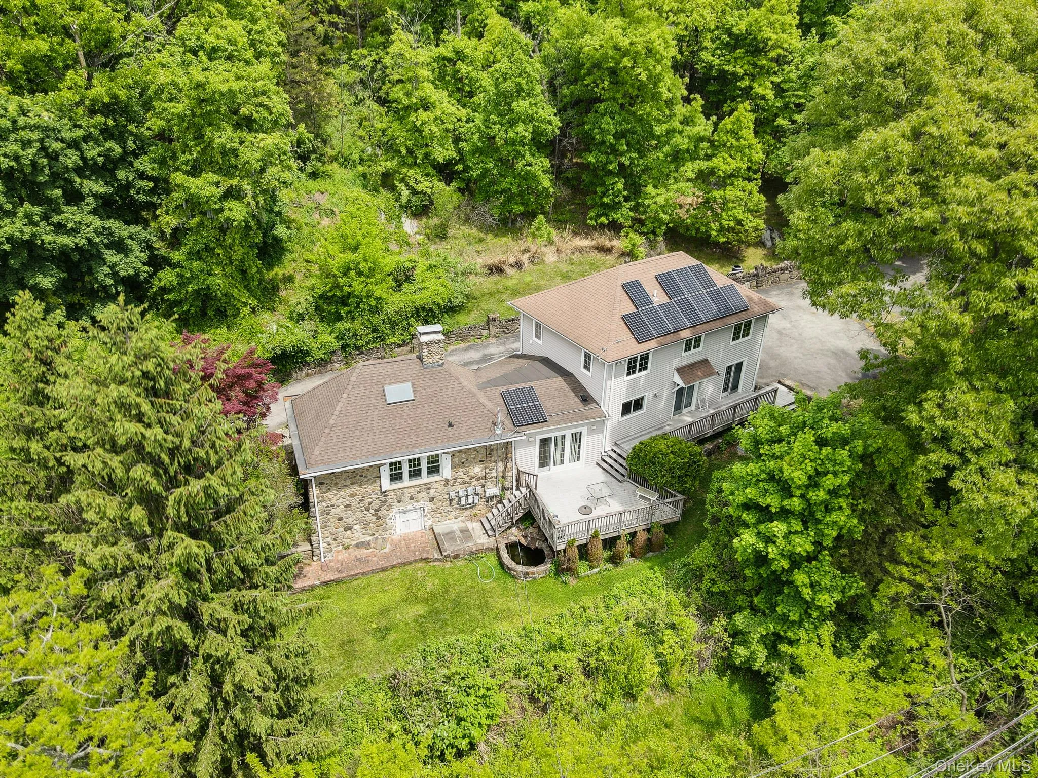 An aerial perspective highlights the property’s unique architecture, expansive outdoor space, and landscaped setting. An aerial perspective highlights the property’s unique architecture, expansive outdoor space, and landscaped setting.
