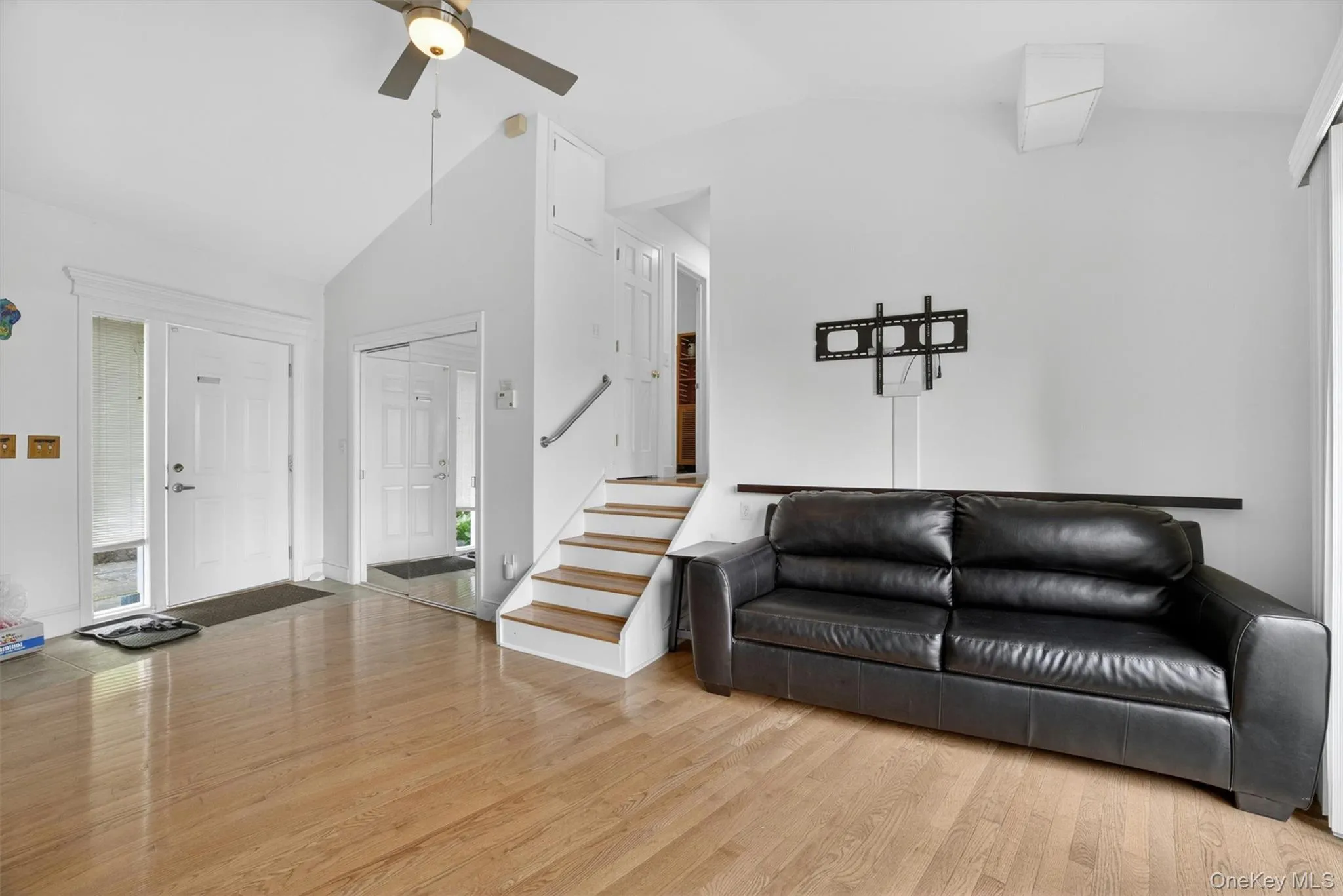 Sun-filled family room with a few steps leading into the main living area, creating an open and inviting flow throughout the home Sun-filled family room with a few steps leading into the main living area, creating an open and inviting flow throughout the home