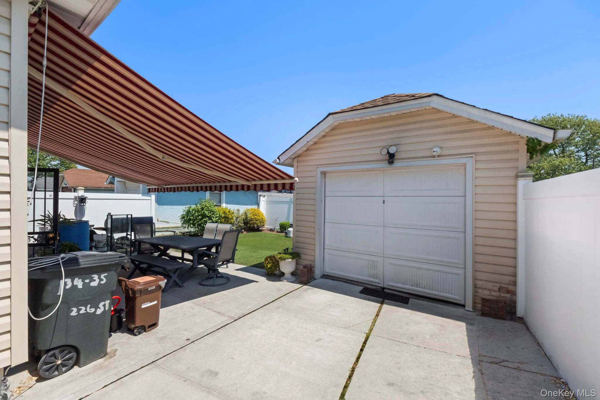 Detached garage with siding exterior and overhead door Detached garage with siding exterior and overhead door