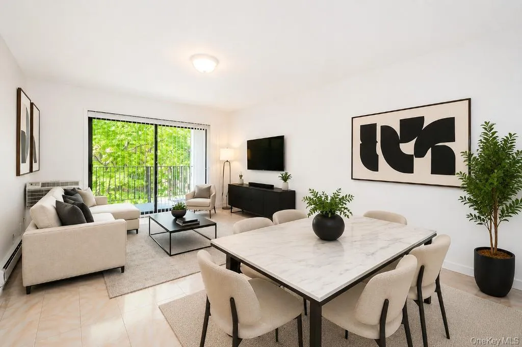 Photo Visually Staged. Living room has sliding glass doors to a private balcony. Photo Visually Staged. Living room has sliding glass doors to a private balcony.