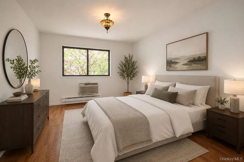 Photo Visually Staged. Large Bedroom has hardwood floors. Photo Visually Staged. Large Bedroom has hardwood floors.