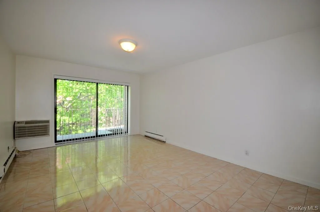 Living room has sliding glass doors to a private balcony. Living room has sliding glass doors to a private balcony.