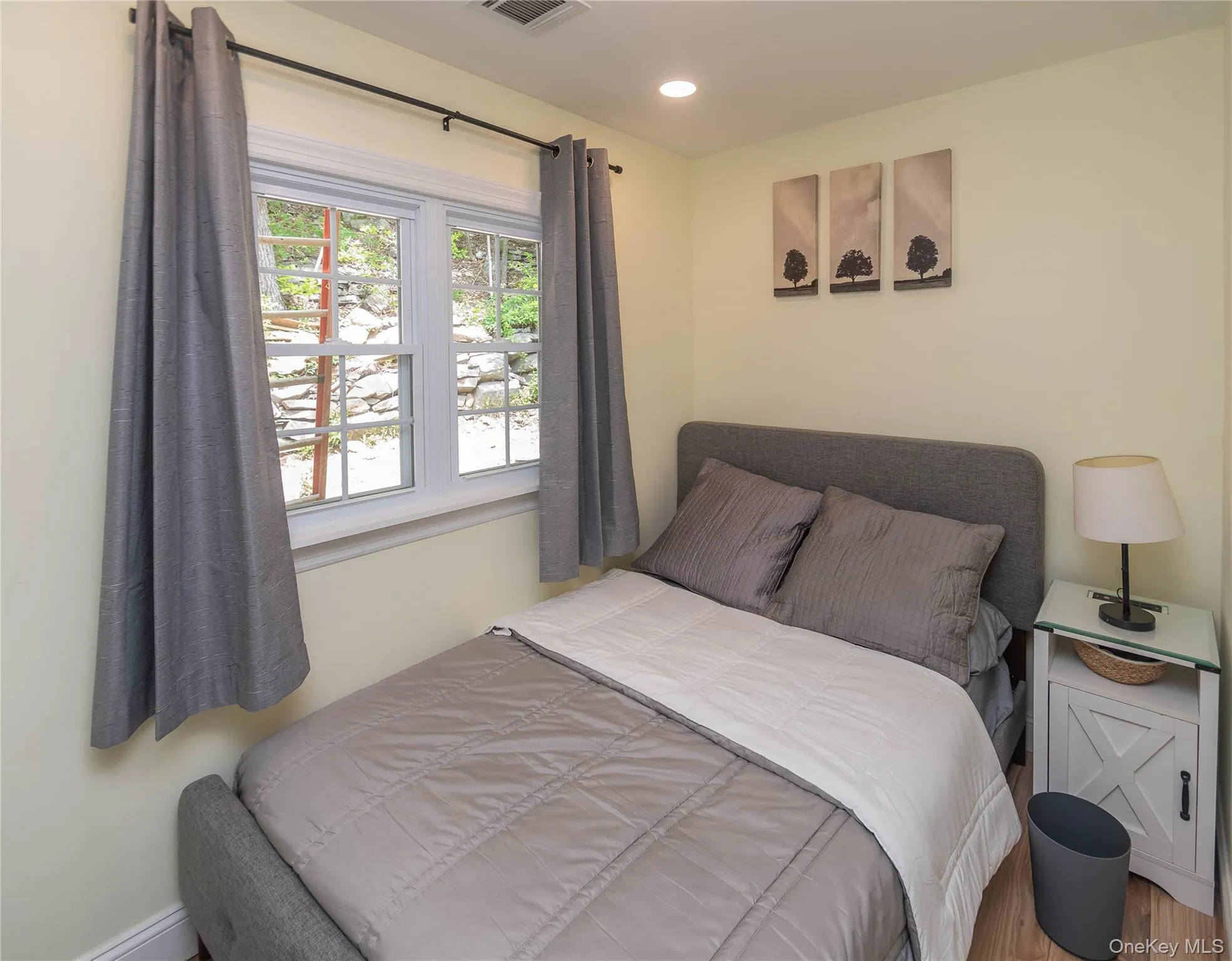 Bedroom featuring a baseboard radiator, wood finished floors, and recessed lighting Bedroom featuring a baseboard radiator, wood finished floors, and recessed lighting
