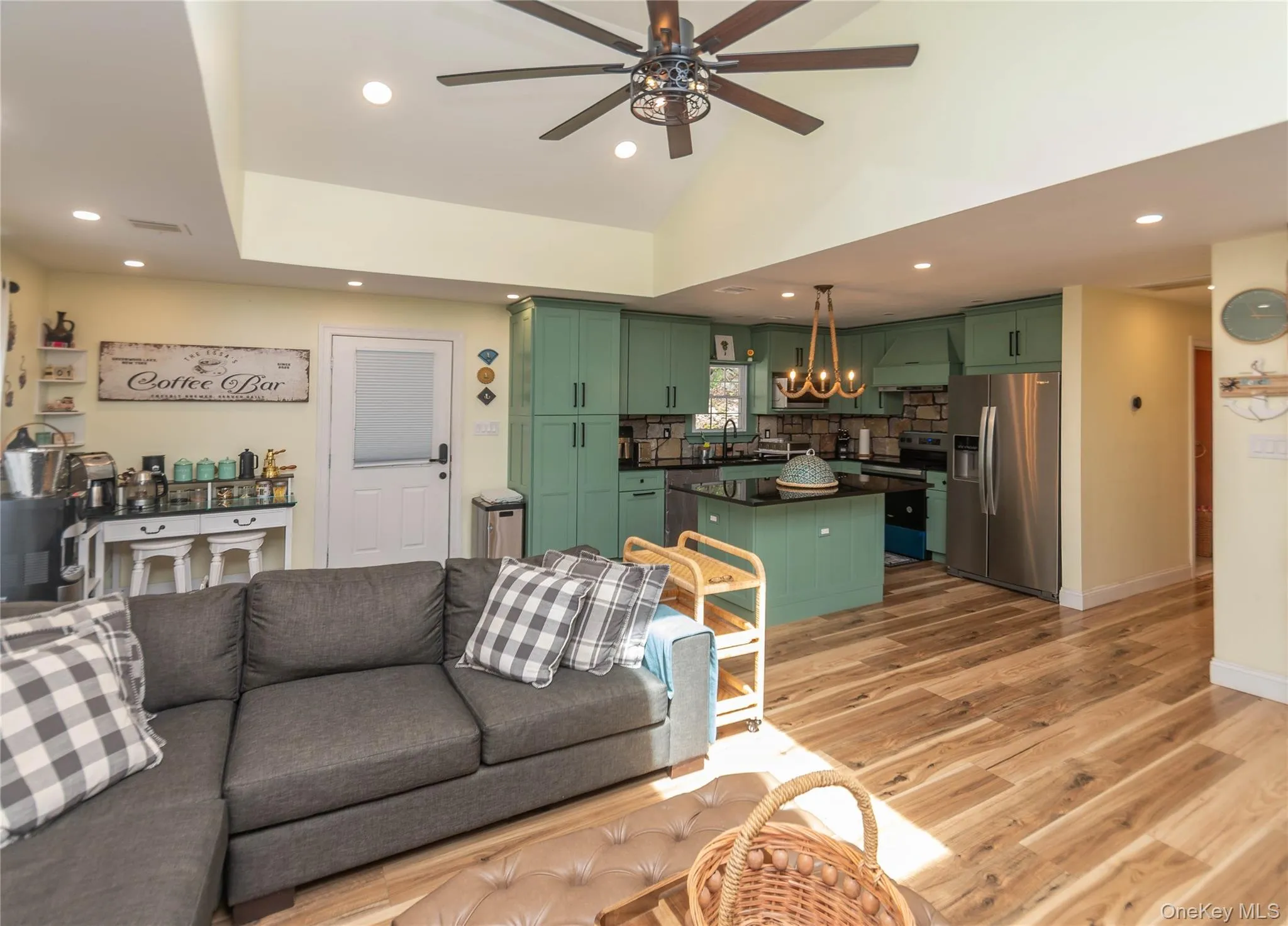 Living area with ceiling fan, recessed lighting, light wood-style flooring, a chandelier, and baseboards Living area with ceiling fan, recessed lighting, light wood-style flooring, a chandelier, and baseboards
