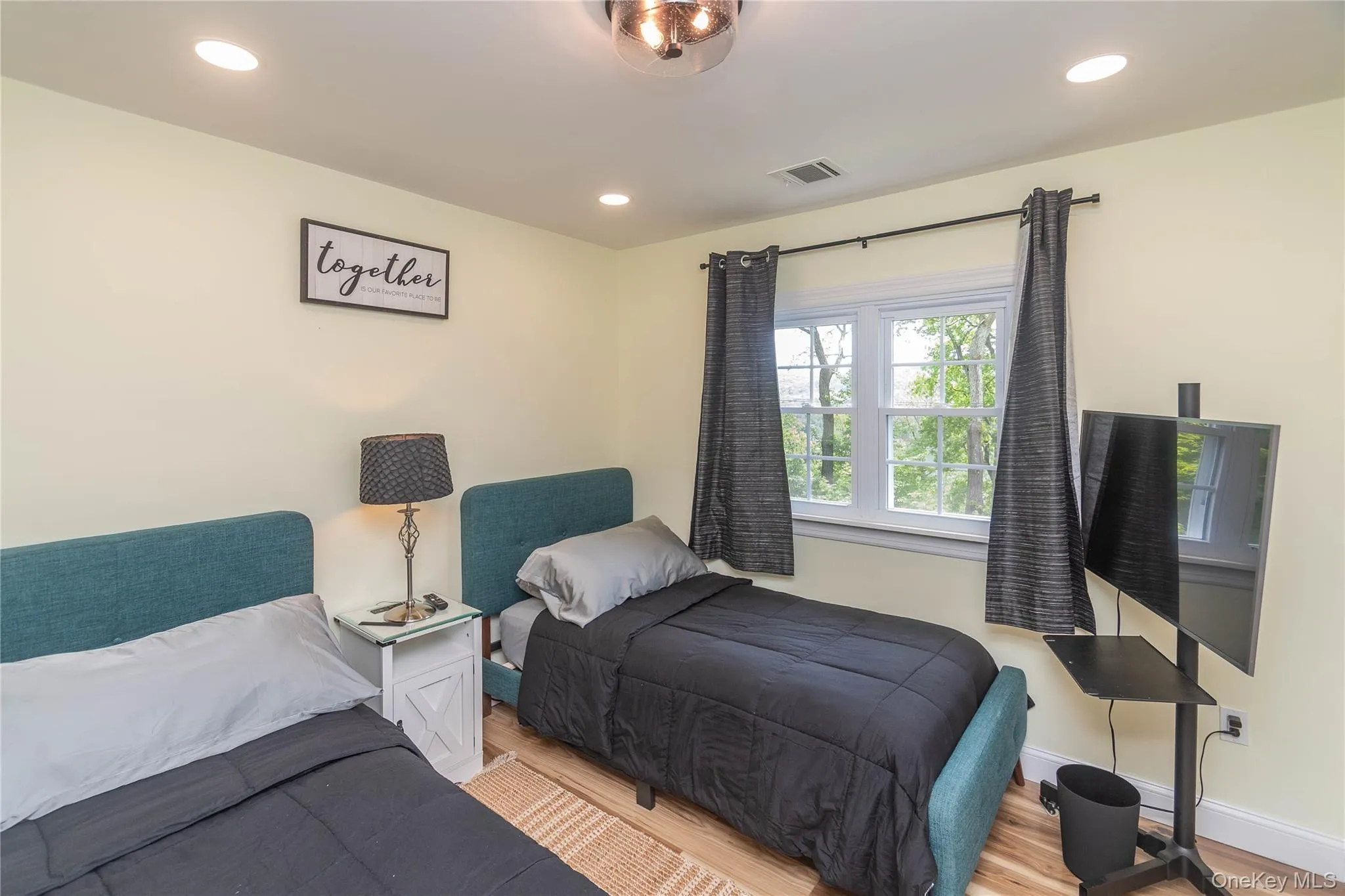 Bedroom with light wood-type flooring, recessed lighting, and baseboards Bedroom with light wood-type flooring, recessed lighting, and baseboards