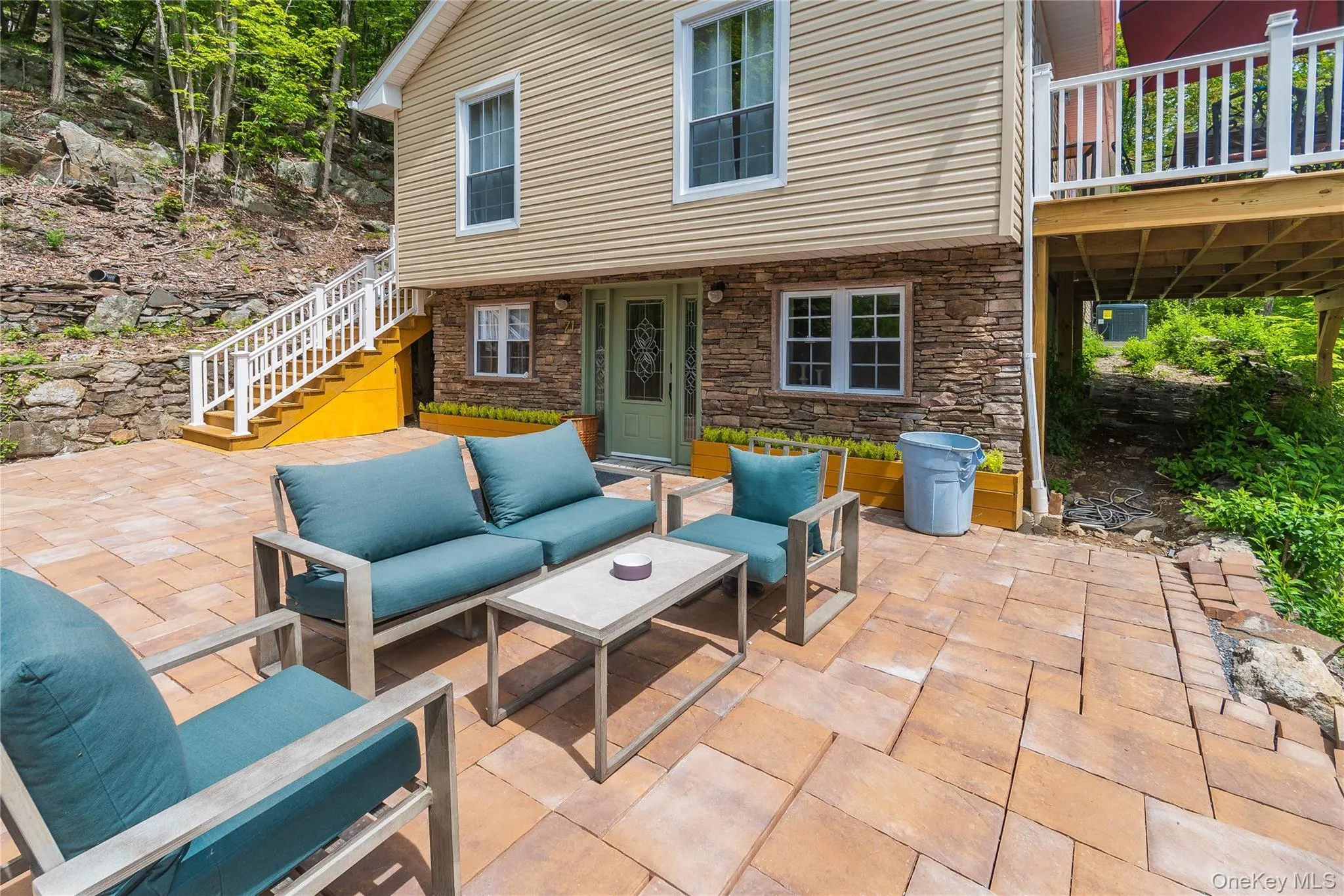 View of patio featuring outdoor lounge area and stairway View of patio featuring outdoor lounge area and stairway