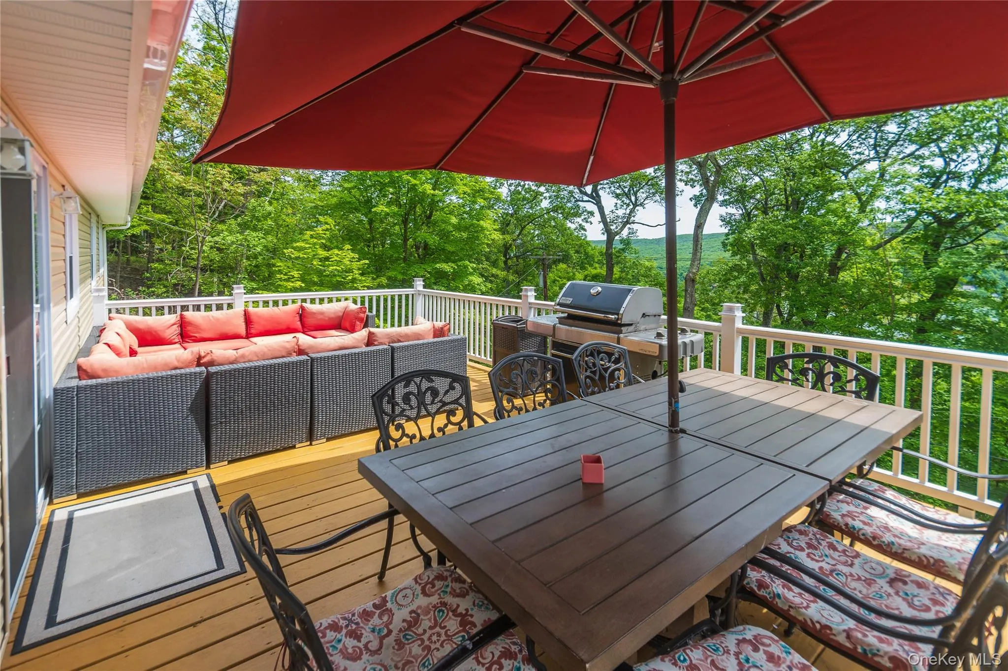 Deck with an outdoor living space, outdoor dining space, and view of scattered trees Deck with an outdoor living space, outdoor dining space, and view of scattered trees