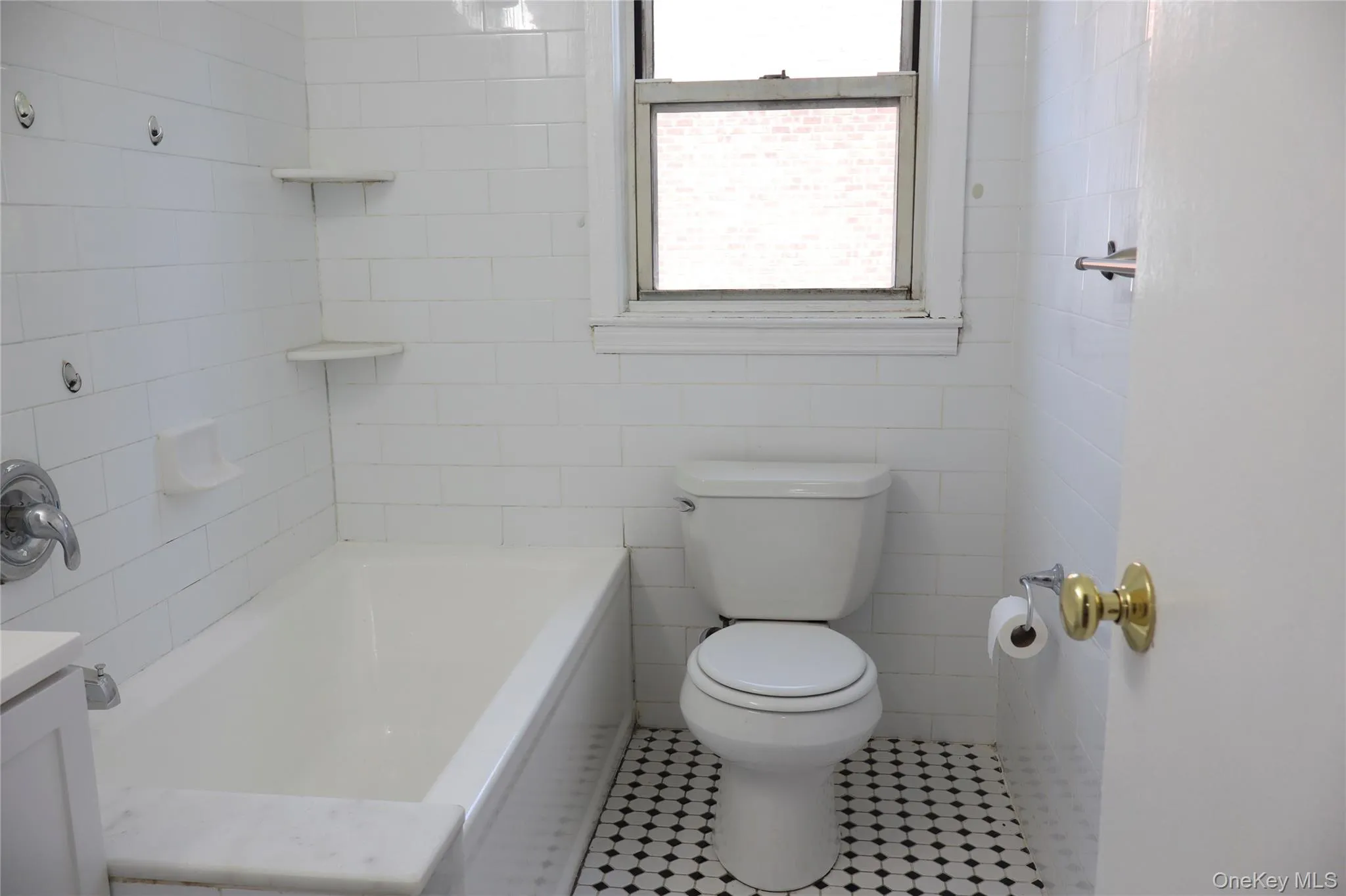 White subway tile bath surround with integrated corner shelving White subway tile bath surround with integrated corner shelving