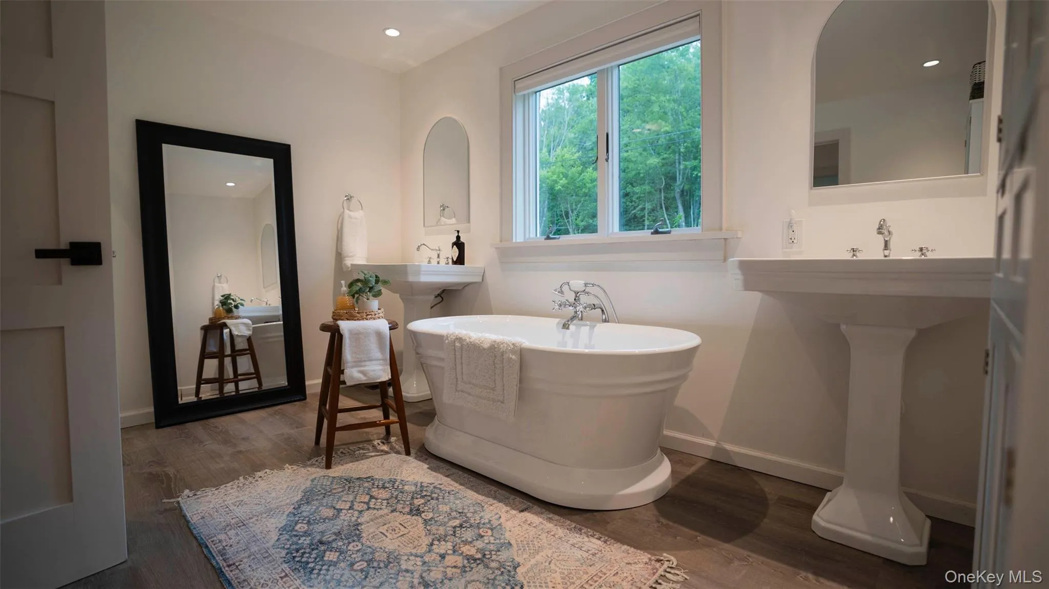 Bathroom featuring wood finished floors, a freestanding bath, and recessed lighting Bathroom featuring wood finished floors, a freestanding bath, and recessed lighting