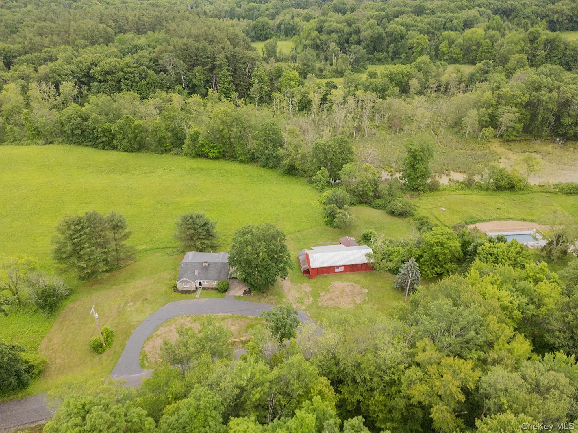 View of rural area featuring a heavily wooded area View of rural area featuring a heavily wooded area