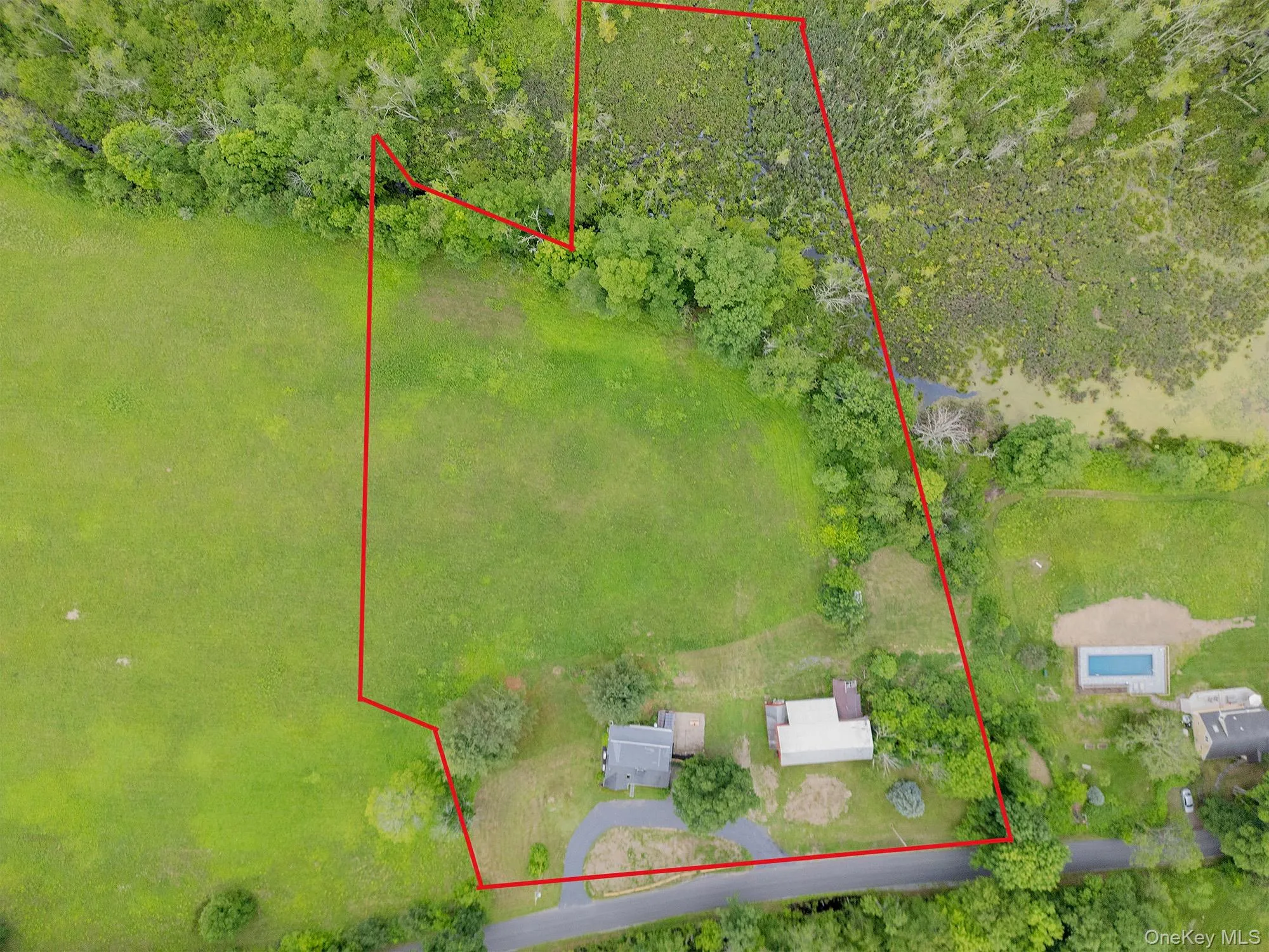 Aerial view of property and surrounding area with property parcel outlined Aerial view of property and surrounding area with property parcel outlined