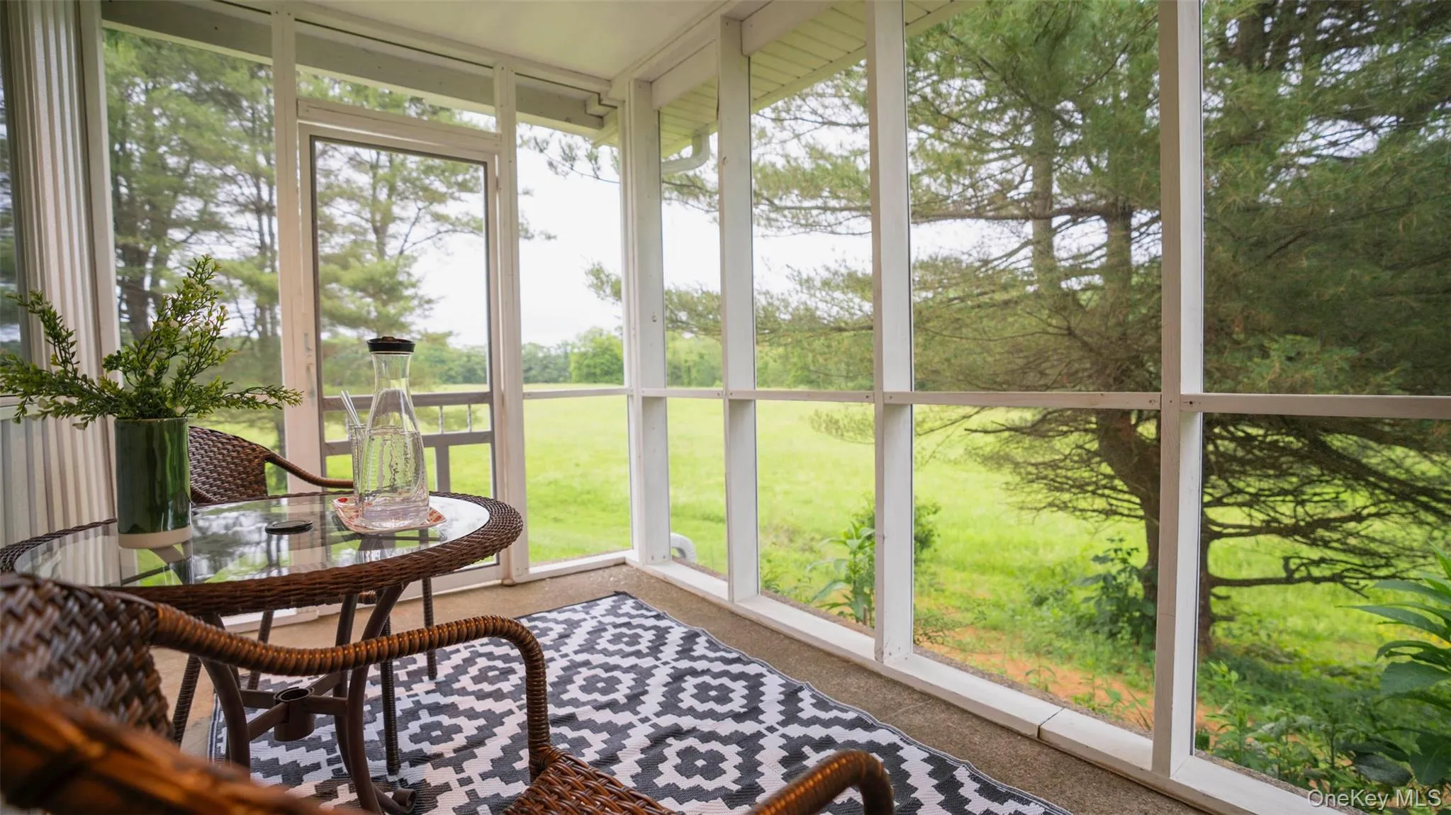 Sunroom / solarium featuring a water view Sunroom / solarium featuring a water view