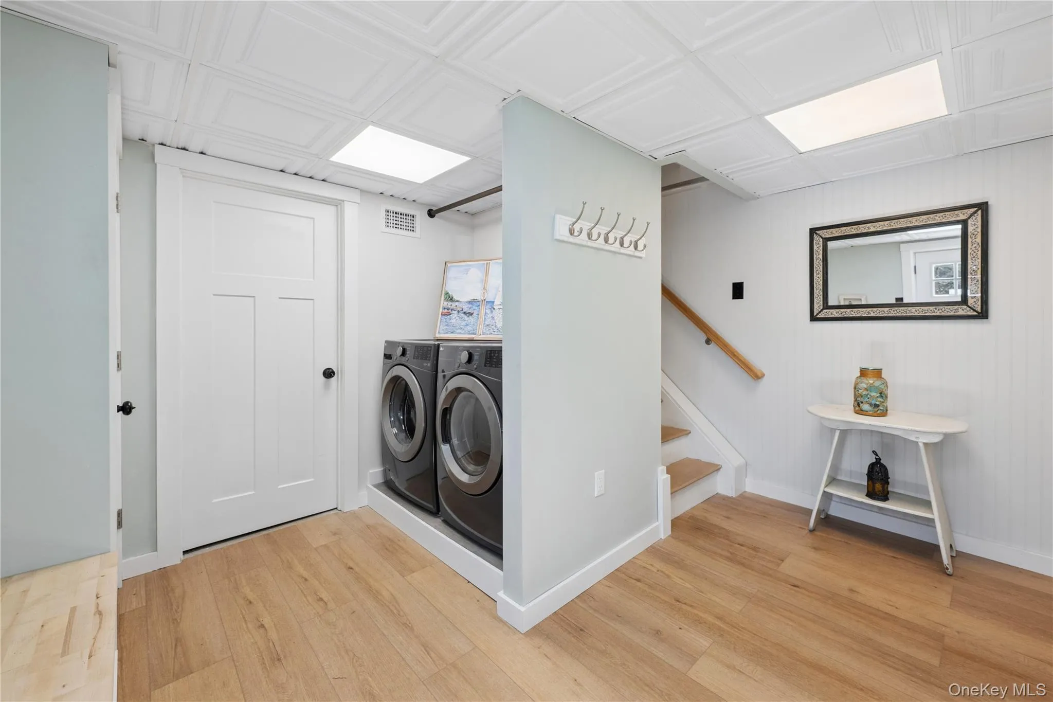 ground level entry with common laundry area and stairs to main floor ground level entry with common laundry area and stairs to main floor