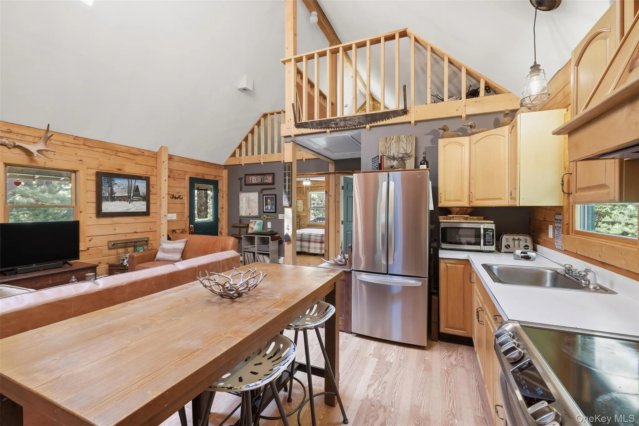 Stainless steel appliances, light wood cabinets, eat in kitchen setup Stainless steel appliances, light wood cabinets, eat in kitchen setup