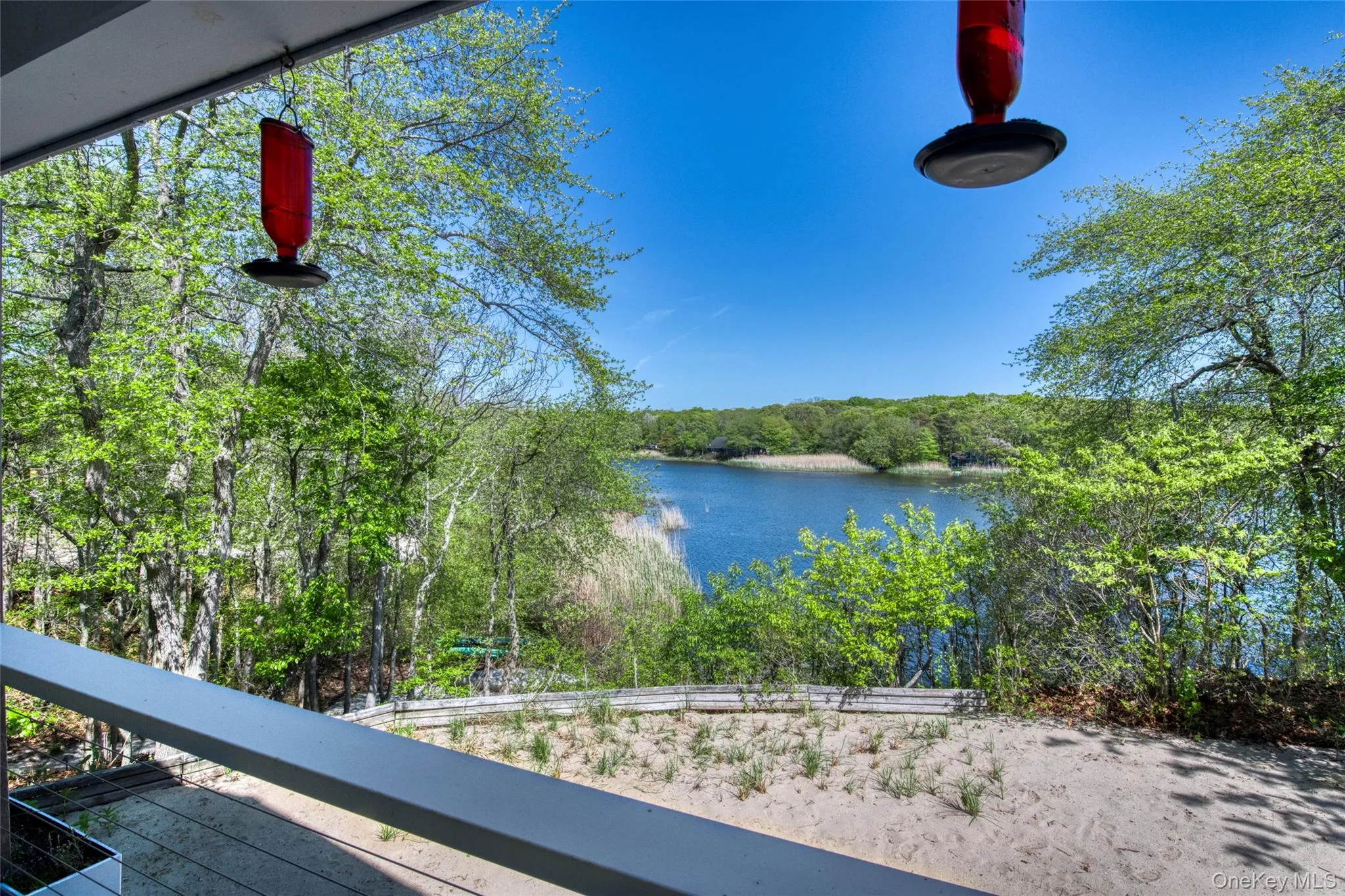Covered upper back porch with dining table overlooking Great Pond Covered upper back porch with dining table overlooking Great Pond